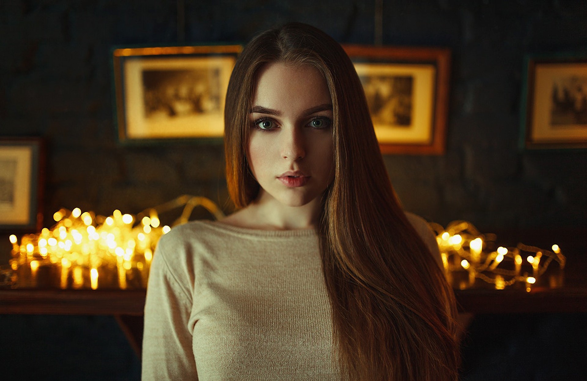 Portrait of a young woman with string lights HD Wallpaper