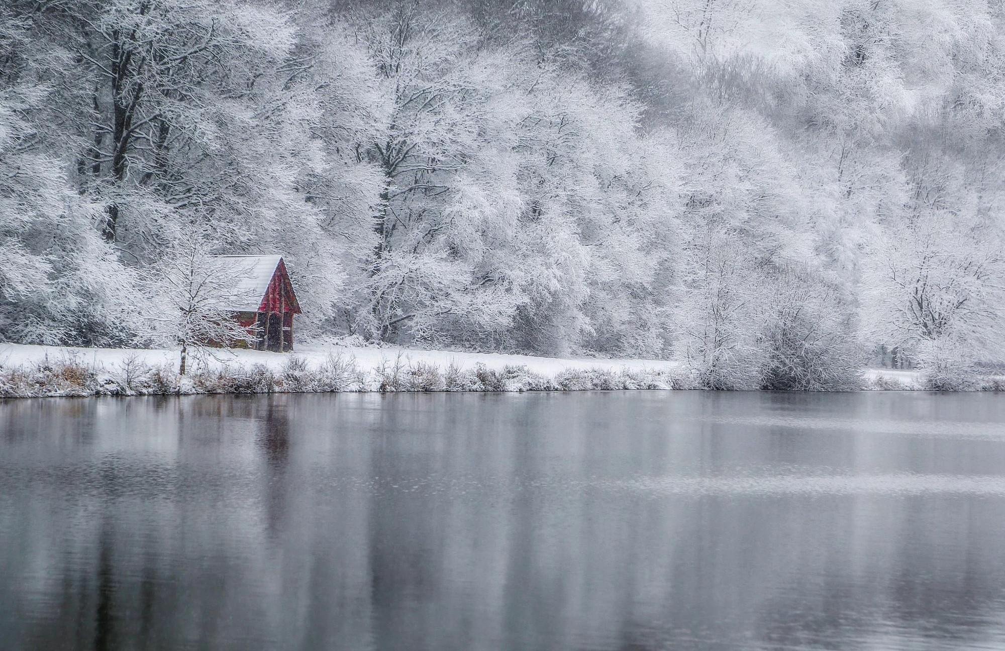 Red hut by a lake in winter snow HD Wallpaper