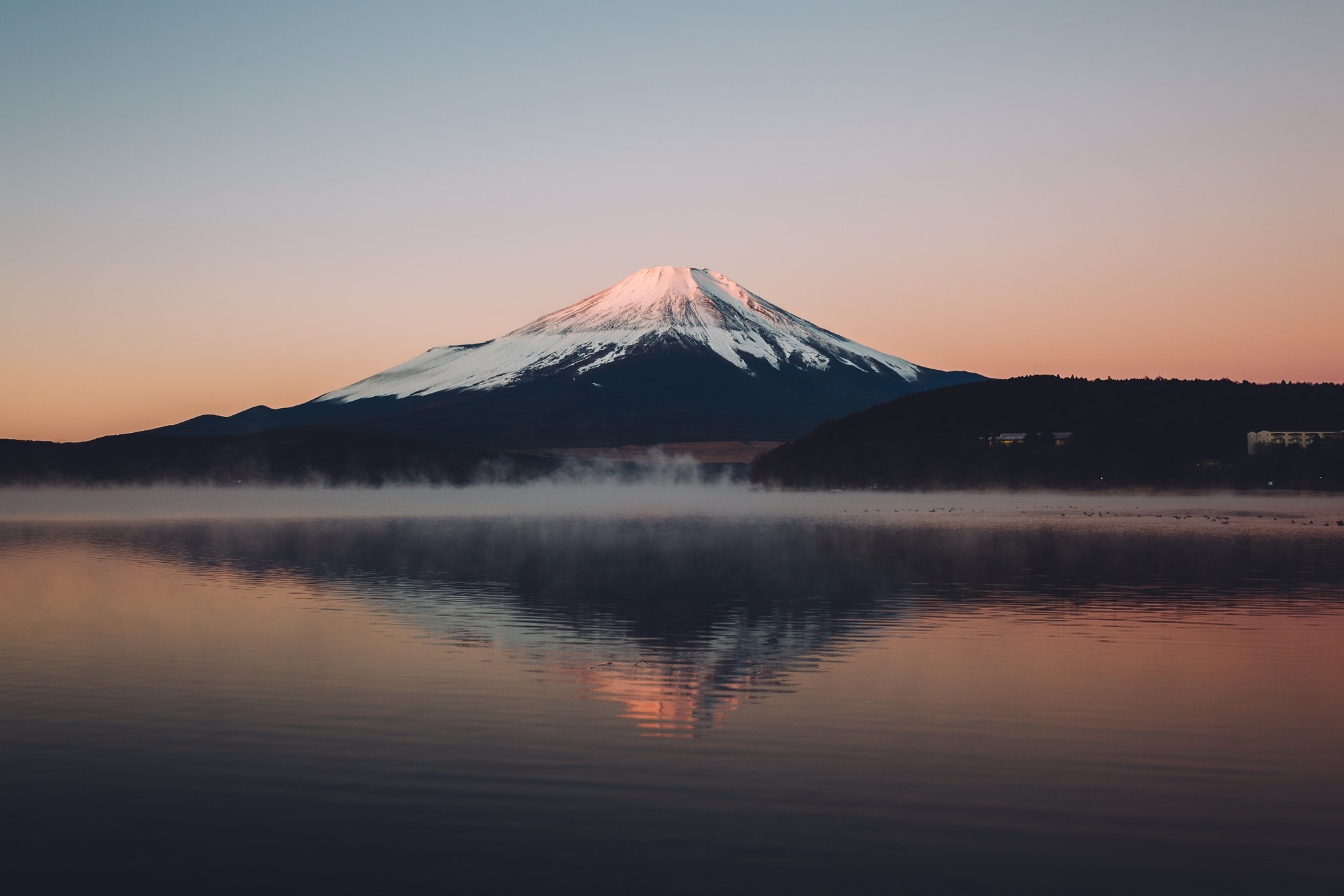 Mount Fuji reflected in a misty lake at sunrise HD Wallpaper