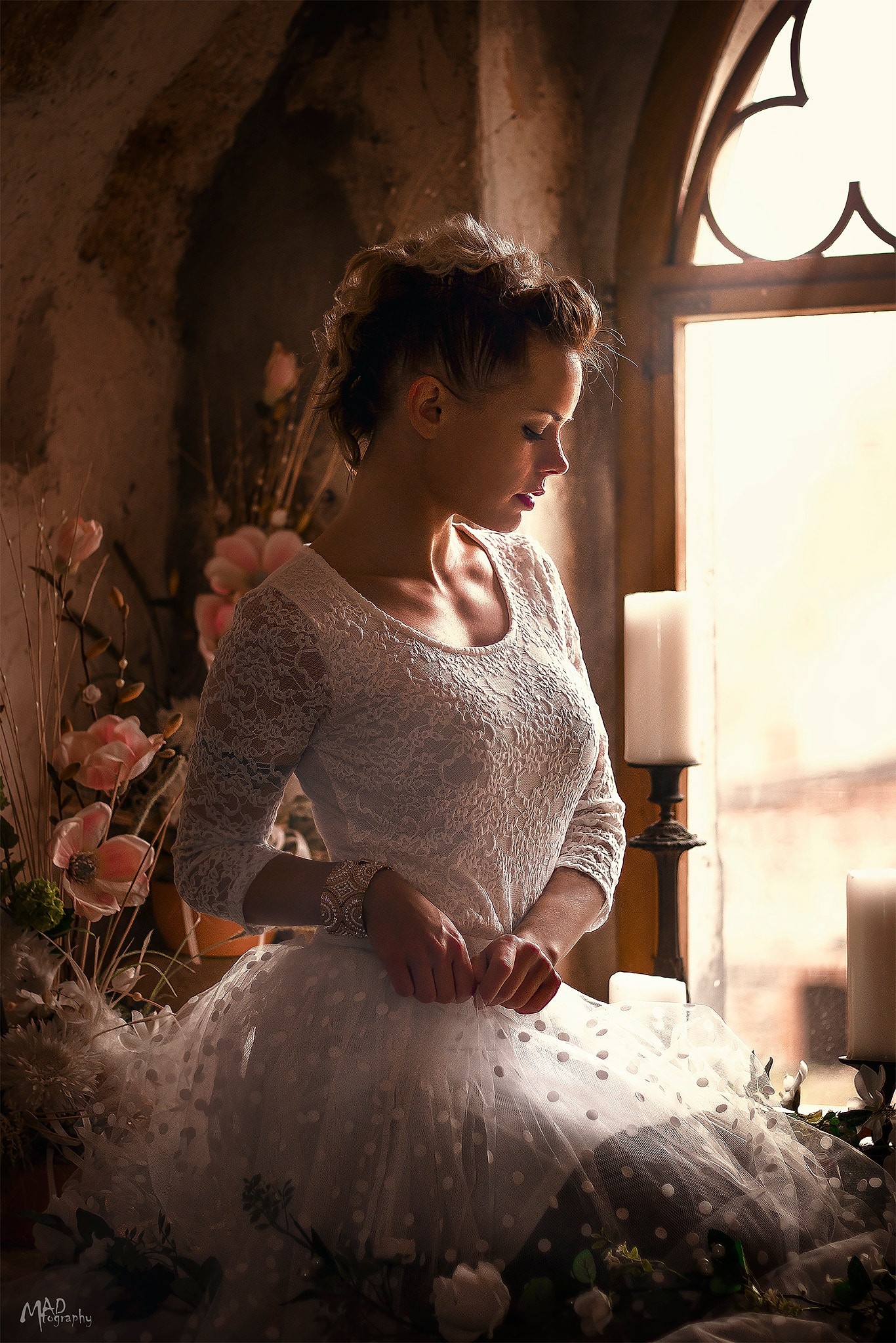 Woman in white lace dress by window with flowers and candles HD Wallpaper