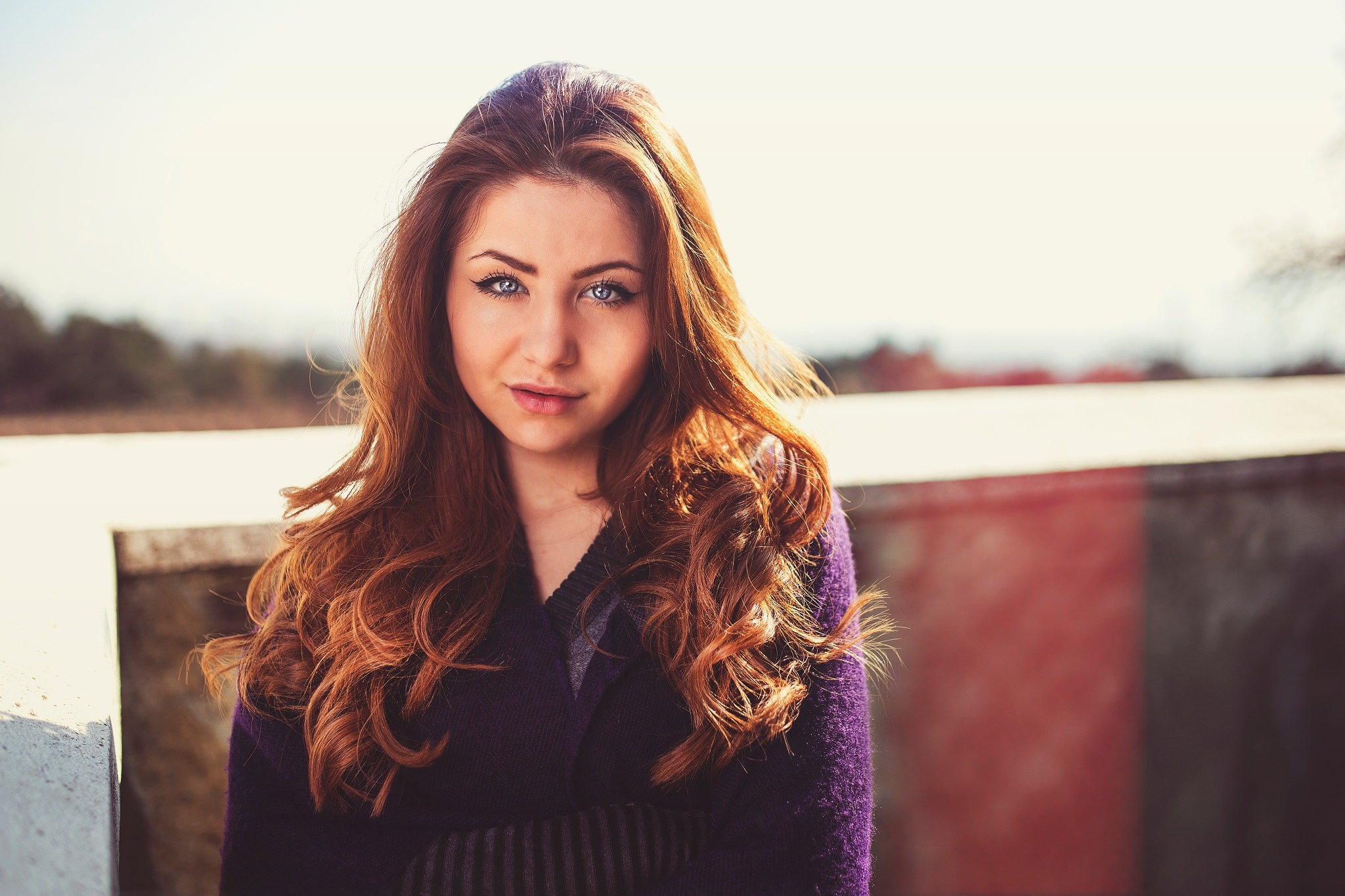 Woman with long auburn hair outdoors HD Wallpaper