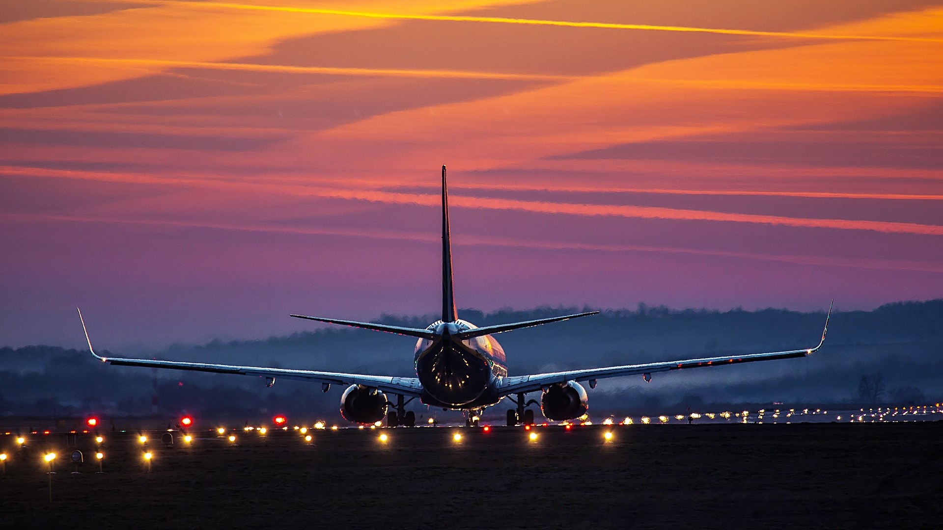 Airplane on runway at sunset HD Wallpaper