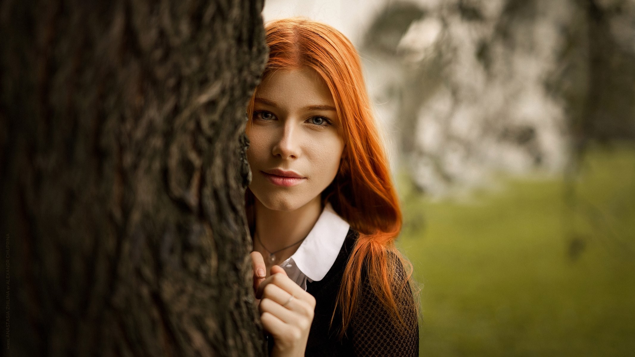 Anastasia Zhilina, a redhead woman, peeking from behind a tree HD Wallpaper
