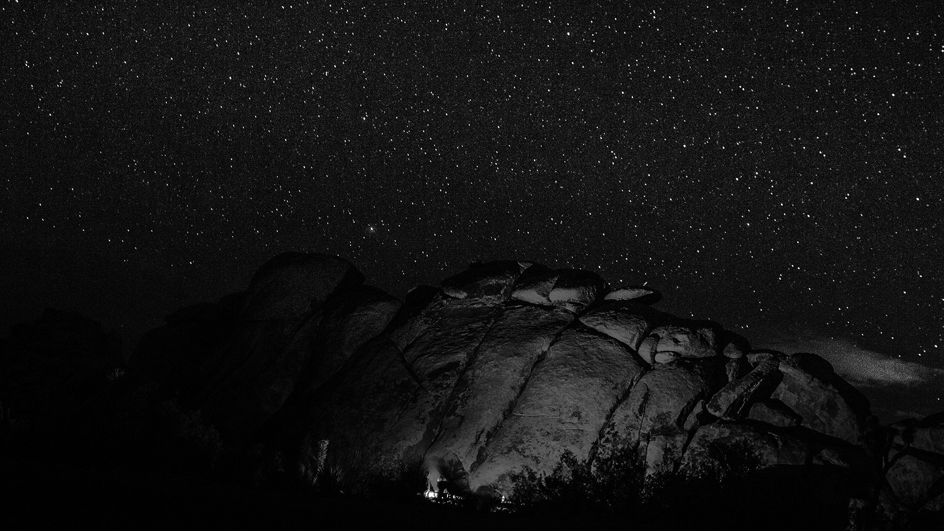 Rocky landscape under a starry night sky HD Wallpaper