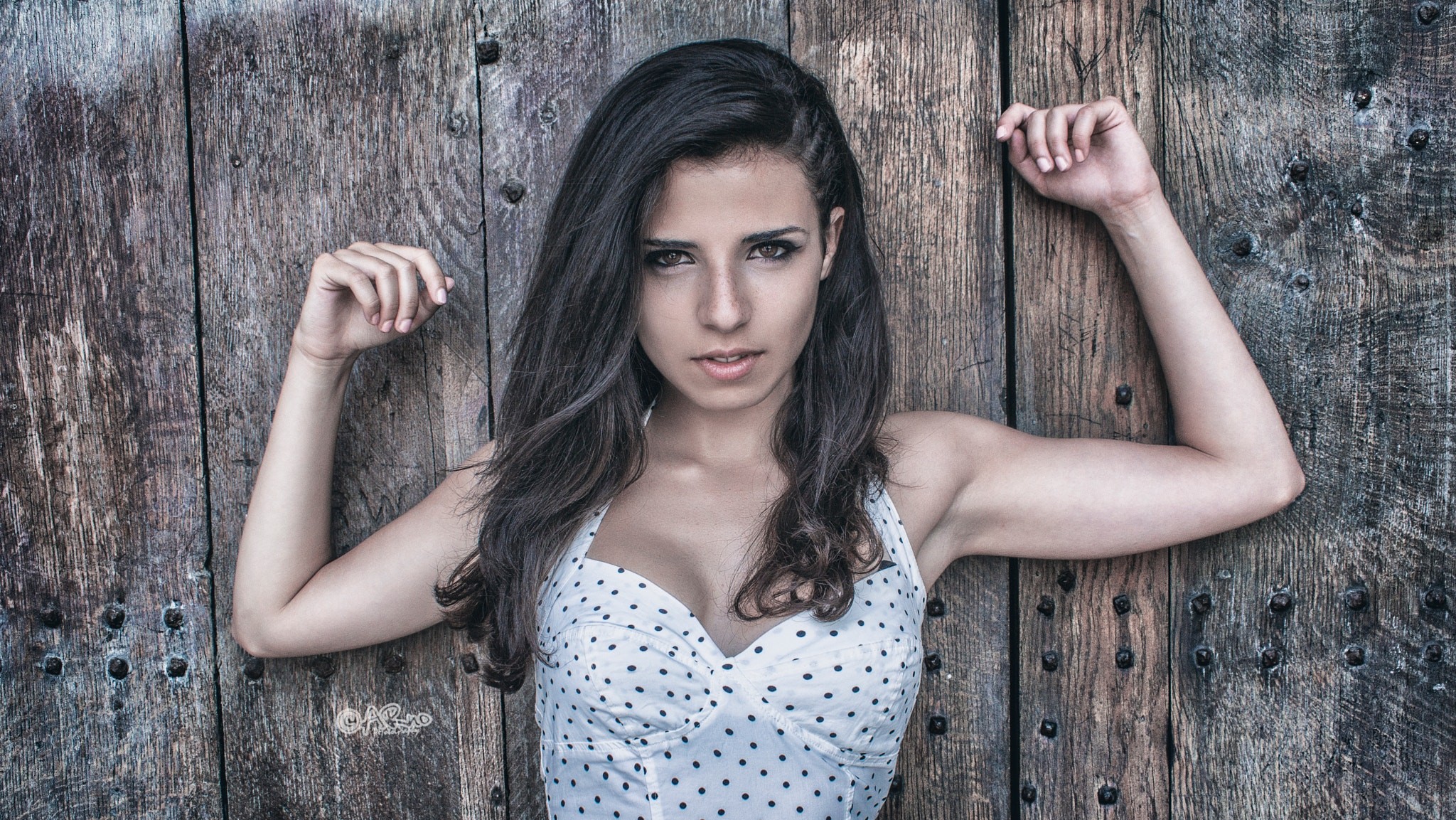 Woman with arms up against a wooden door HD Wallpaper