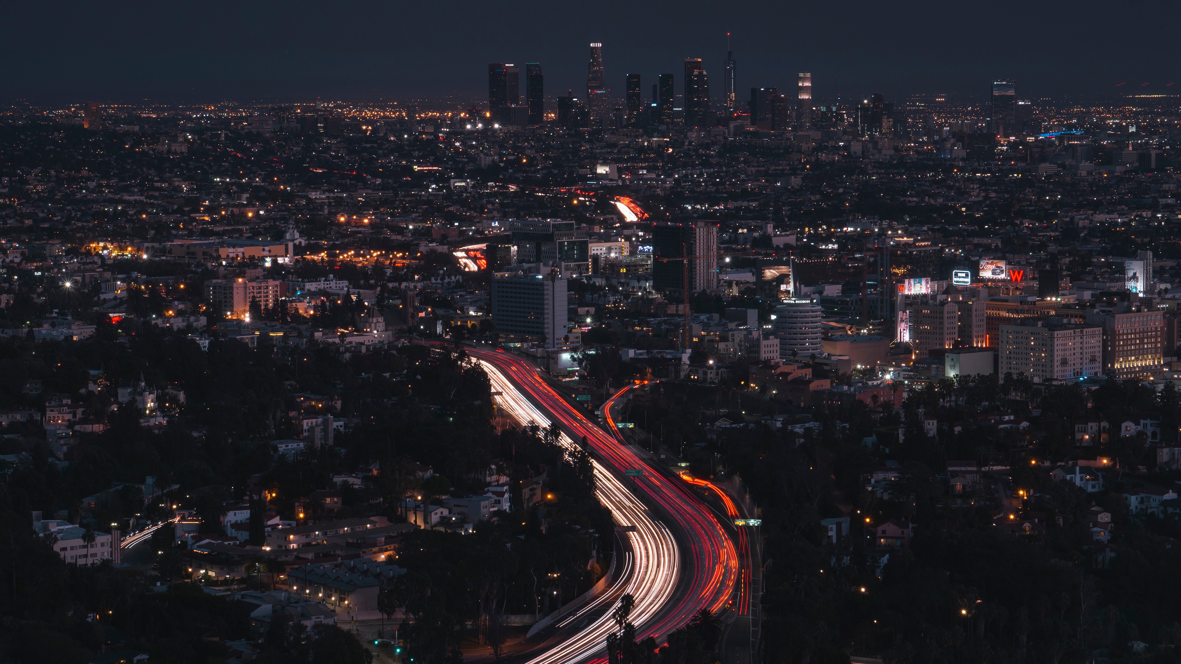 Los Angeles cityscape at night with light trails on highway HD Wallpaper
