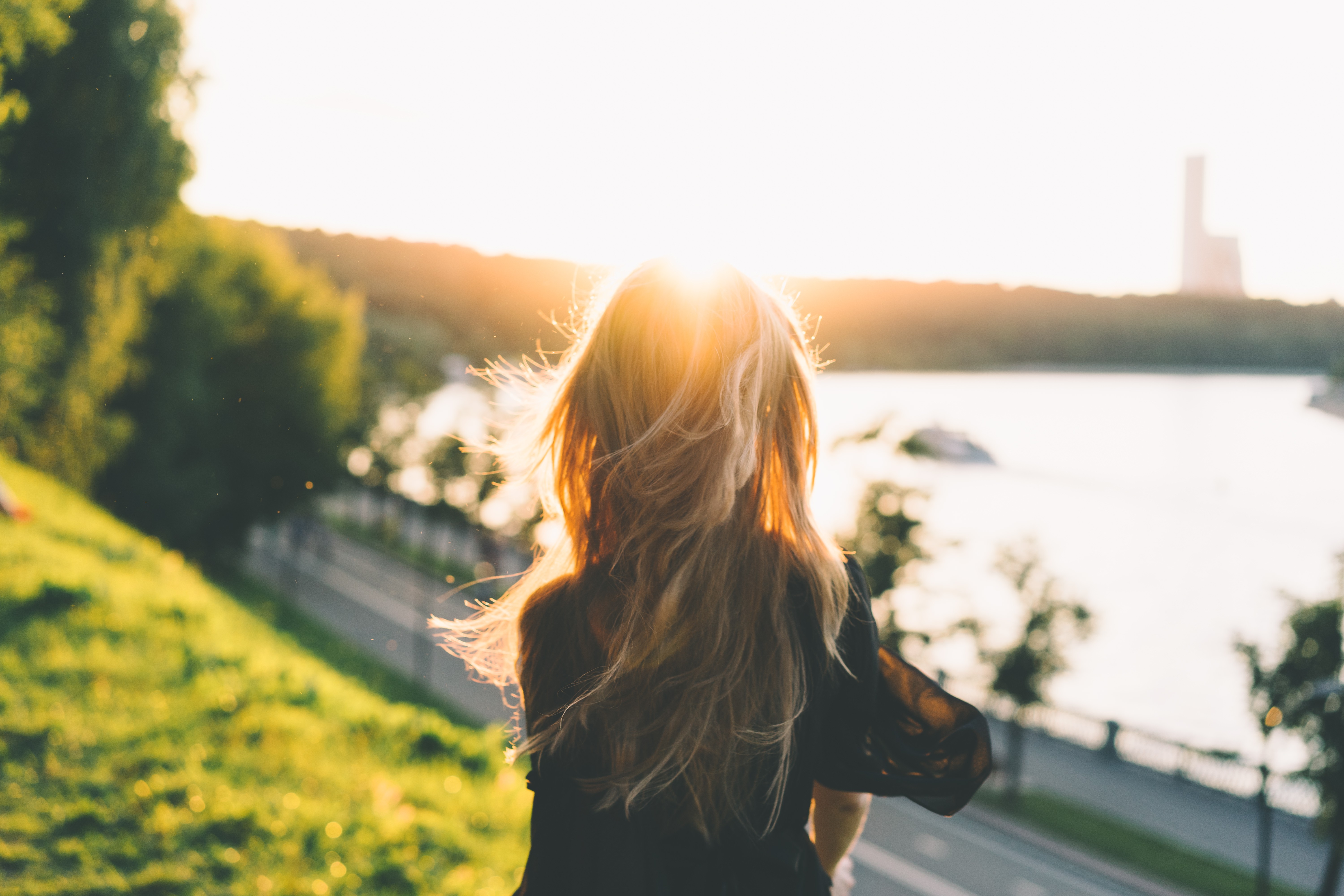 Woman with blonde hair in the sun by the lake HD Wallpaper