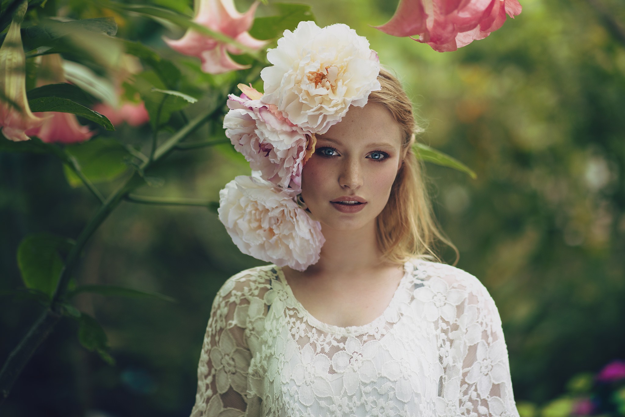 Woman with flowers in her hair outdoors HD Wallpaper