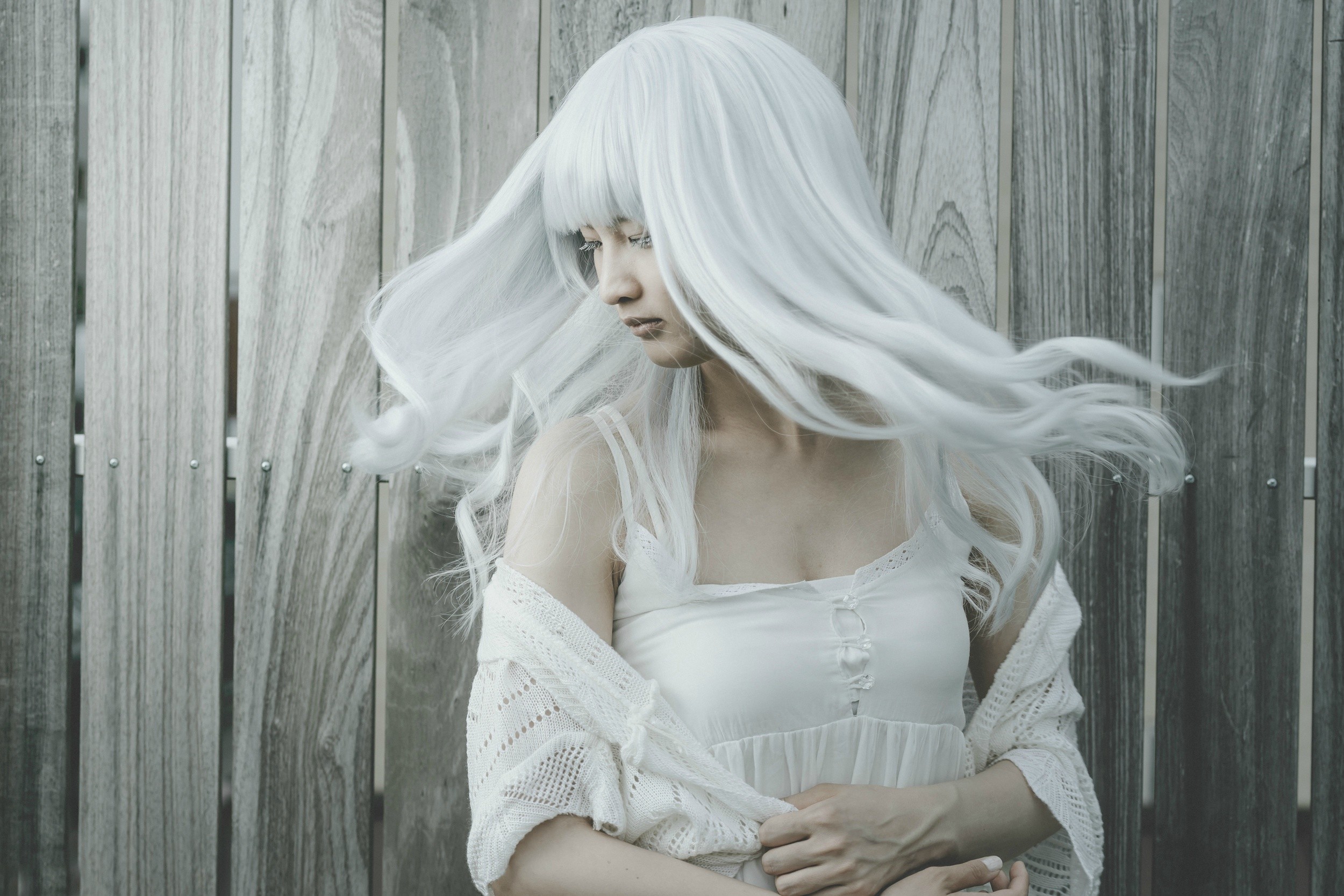 Woman with long white hair in front of wooden fence HD Wallpaper