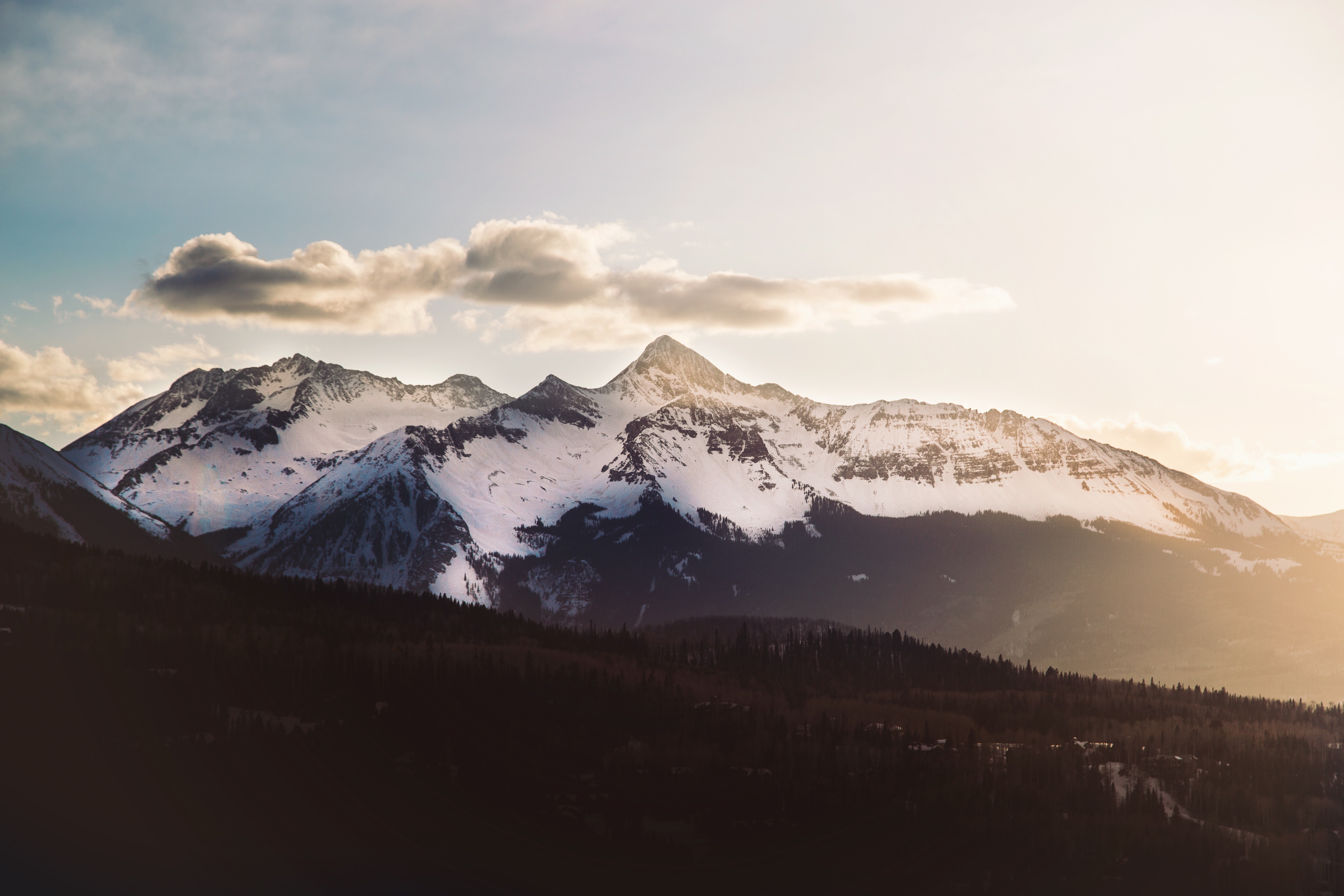 Snow-capped mountains at sunset with clouds HD Wallpaper