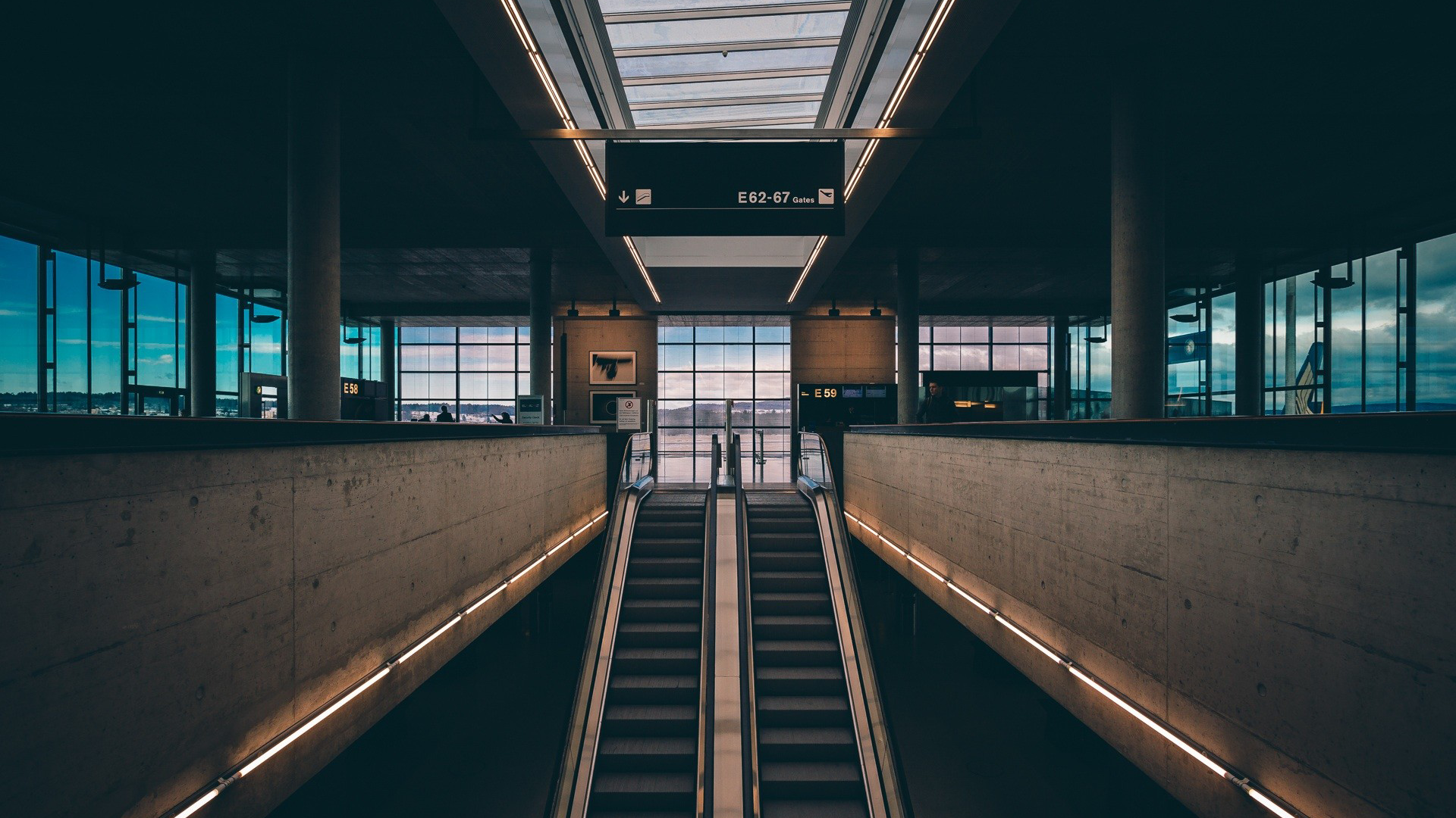 Escalators in a modern airport terminal HD Wallpaper