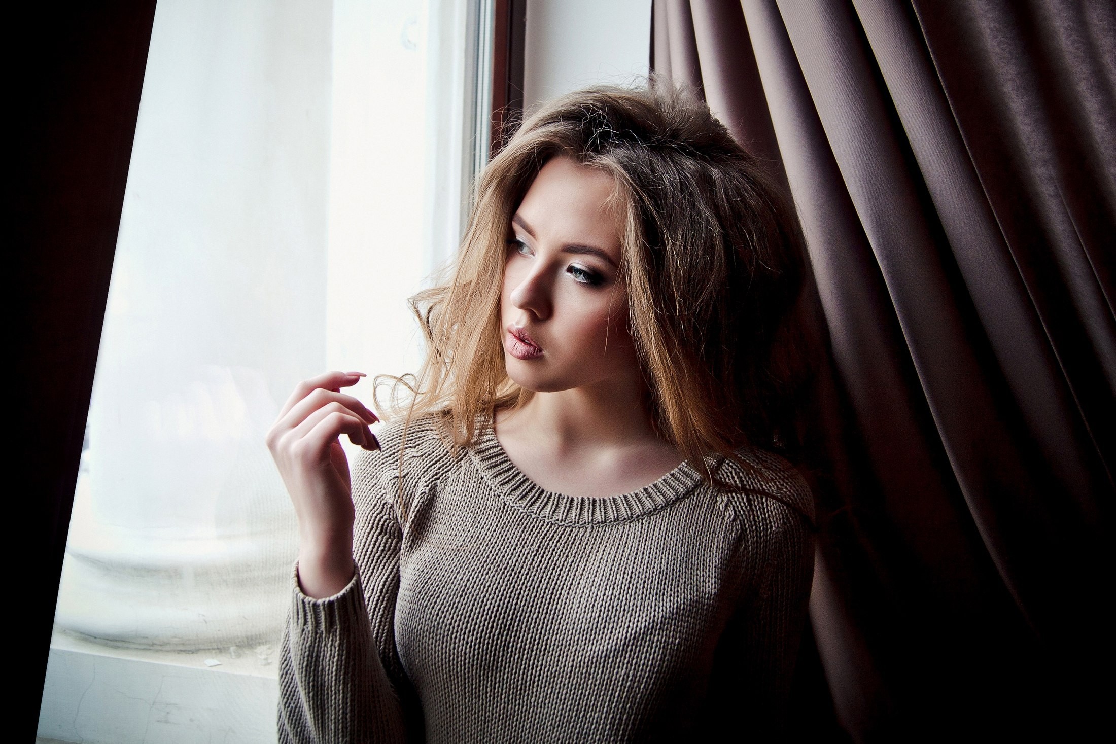 Woman in sweater by the window HD Wallpaper