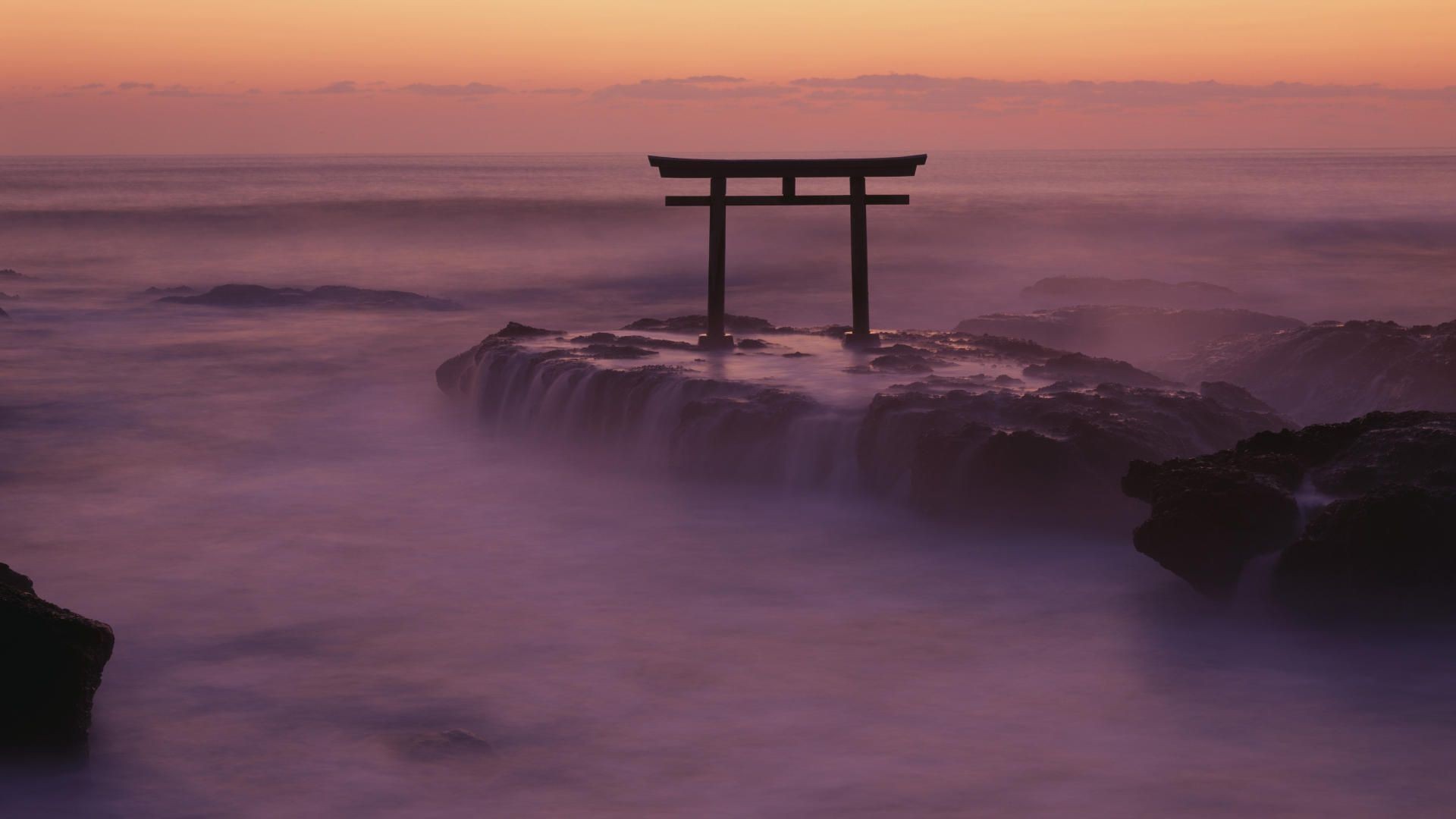 Torii gate on rocks in the sea at sunset HD Wallpaper