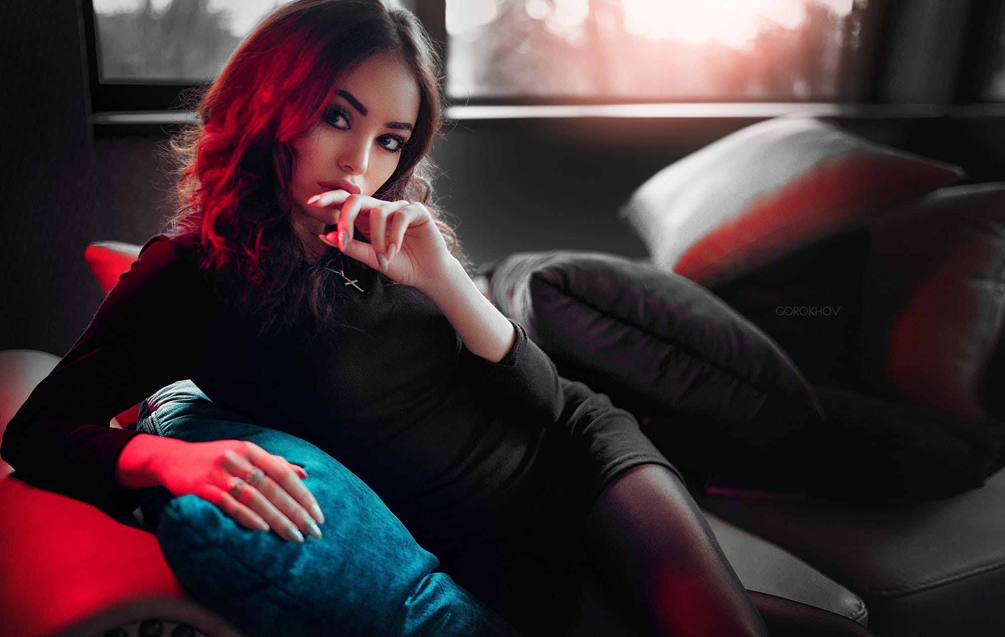 Woman in black dress on a couch with red lighting HD Wallpaper