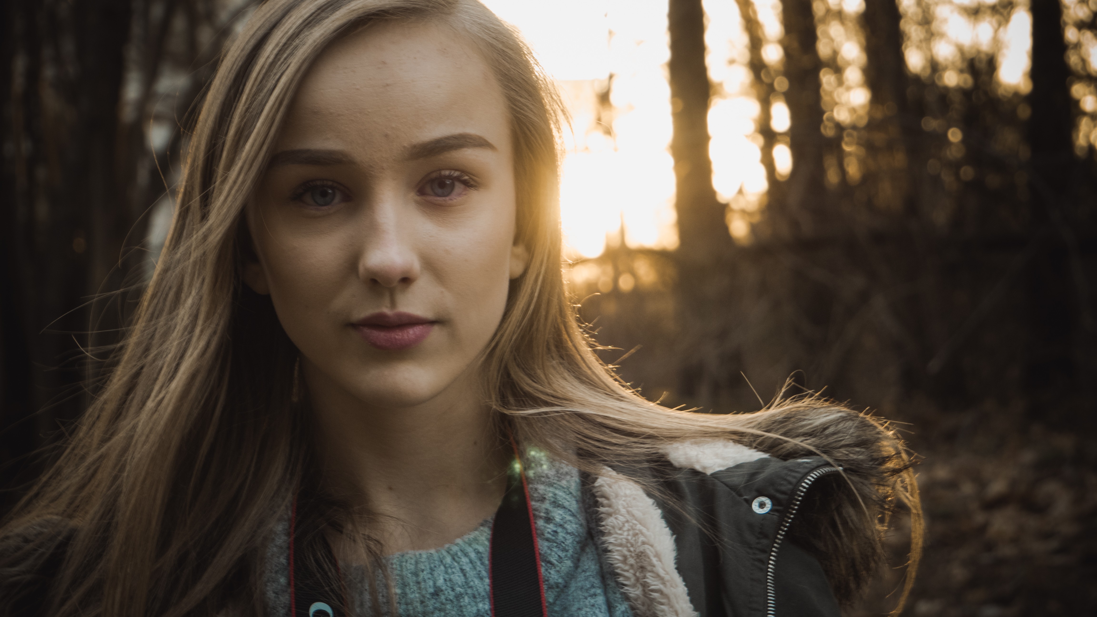 Woman with blonde hair in a jacket outdoors HD Wallpaper