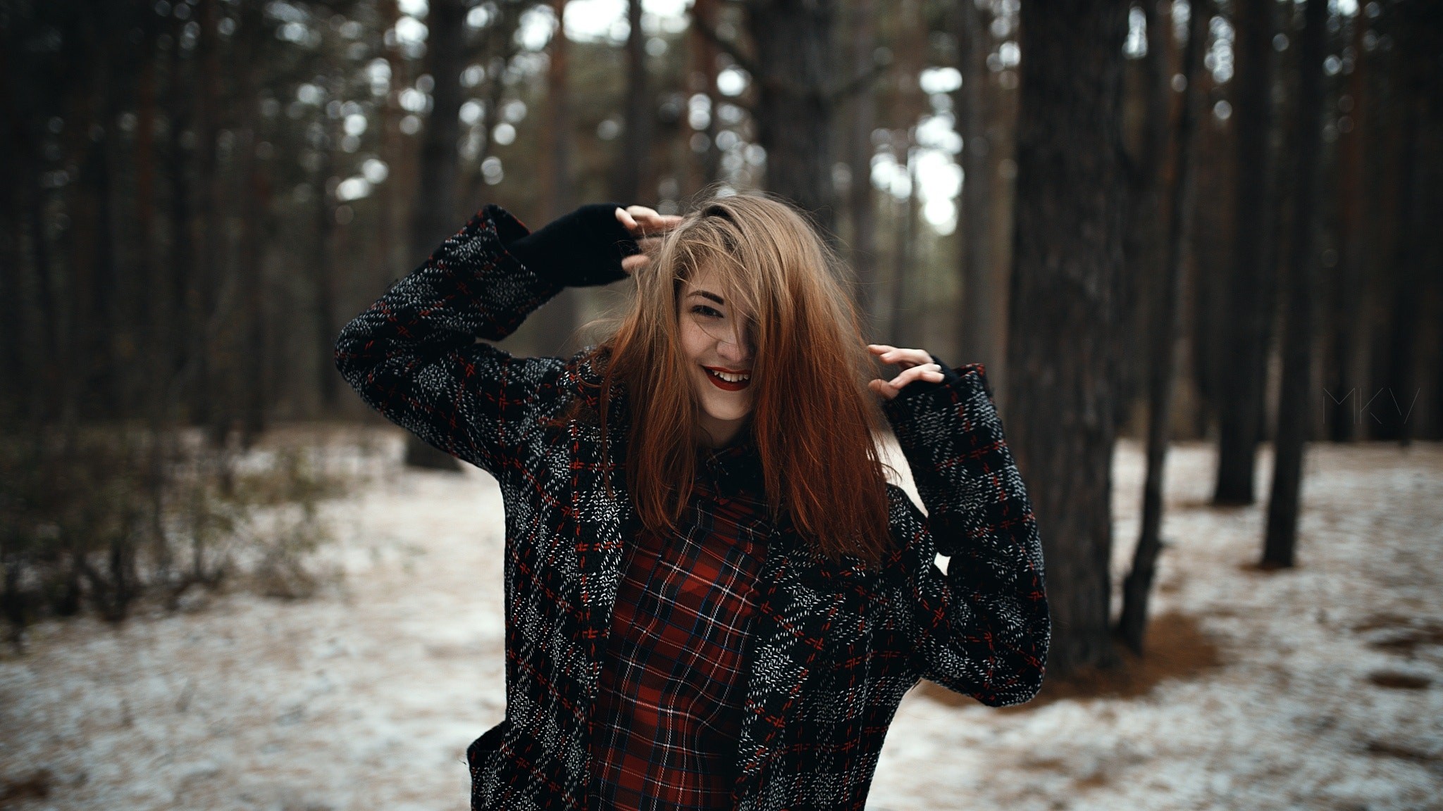 Woman in plaid shirt and coat in forest HD Wallpaper