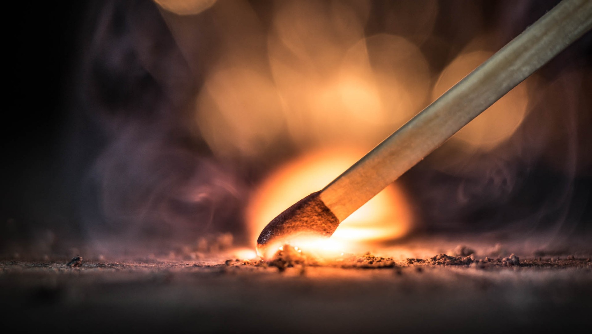 Burning matchstick igniting on a surface HD Wallpaper