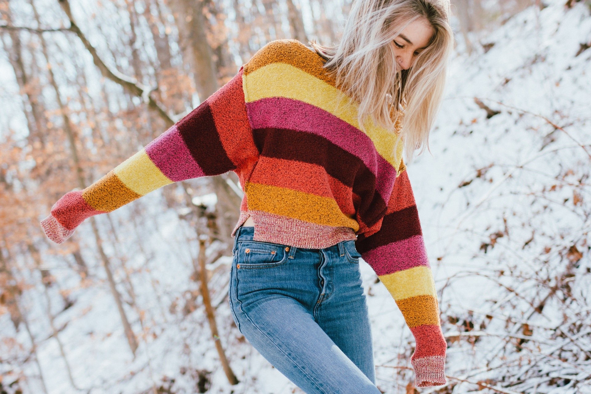 Woman in striped sweater and jeans in snow HD Wallpaper