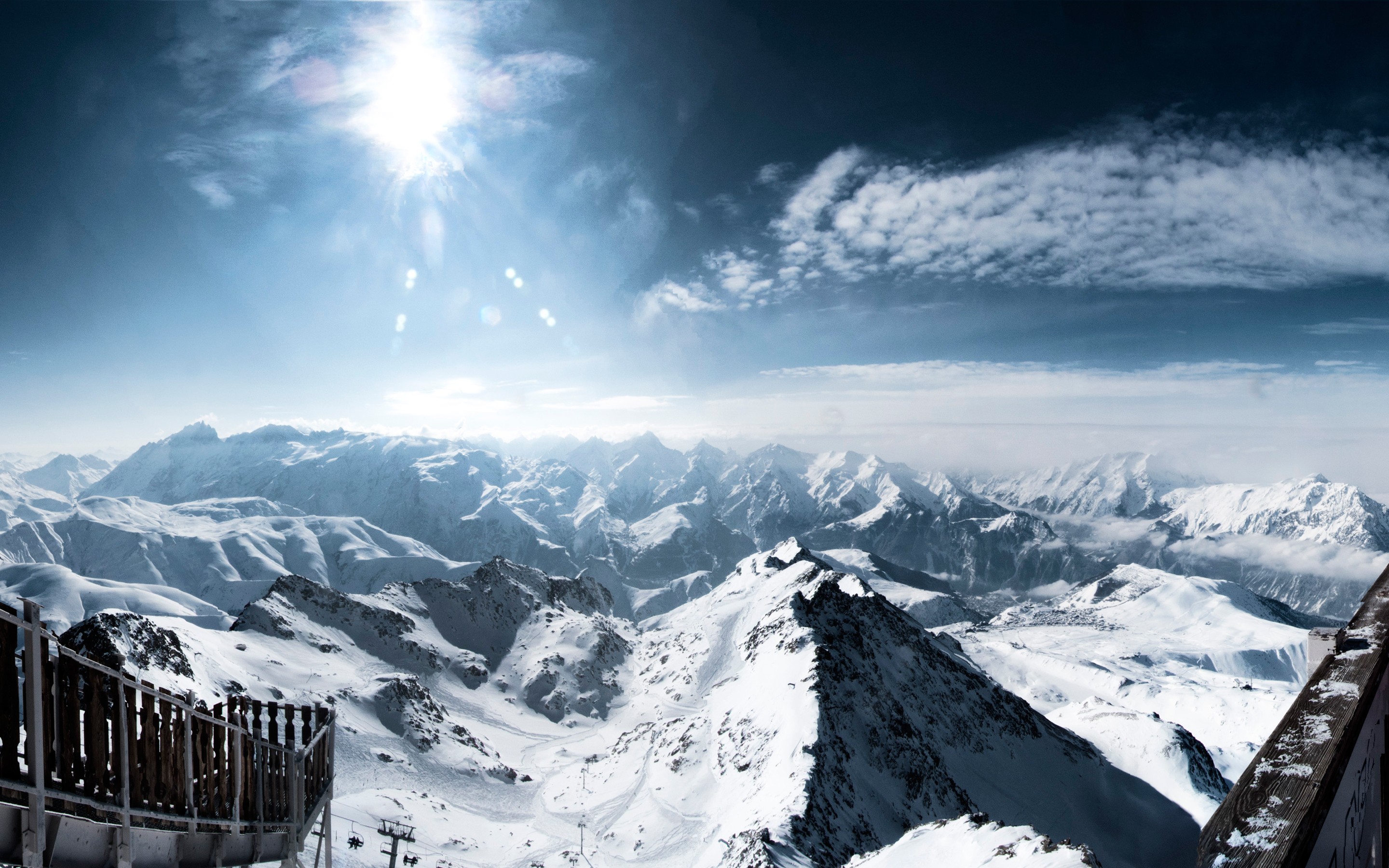 Snowy mountain range with sun and clouds HD Wallpaper