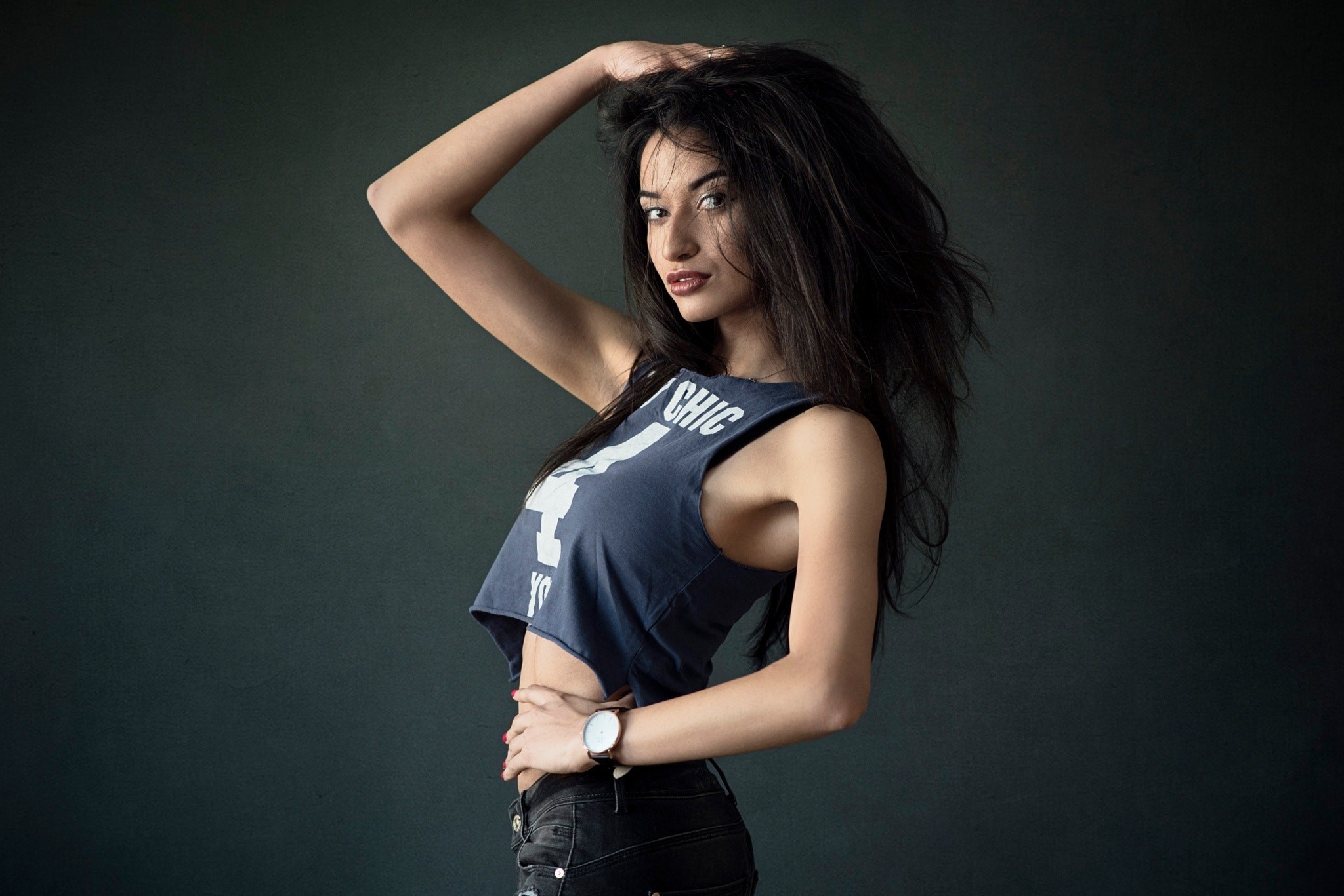 Woman with long wavy hair wearing a crop top and watch HD Wallpaper