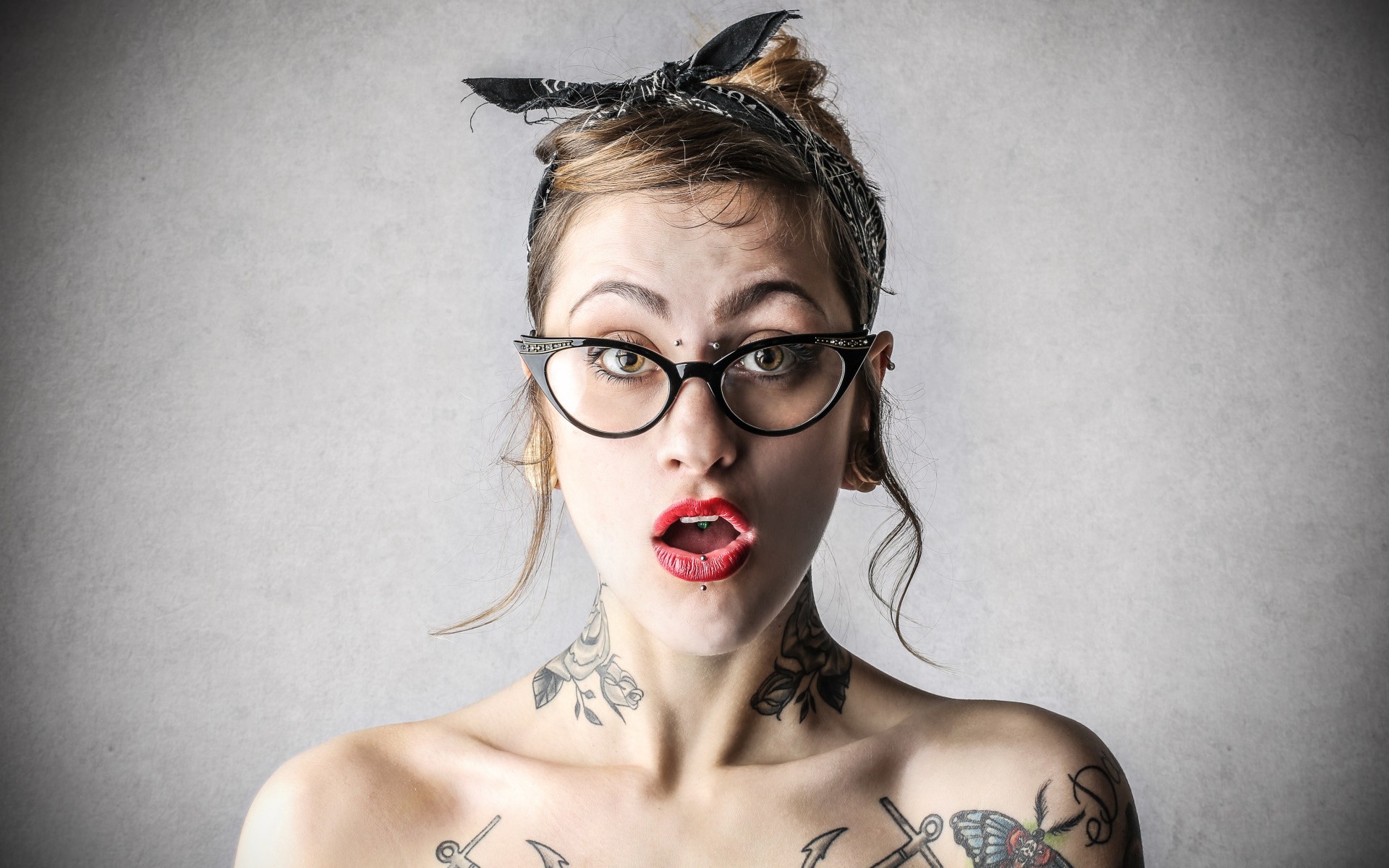 Woman with tattoos and glasses wearing a bandana HD Wallpaper