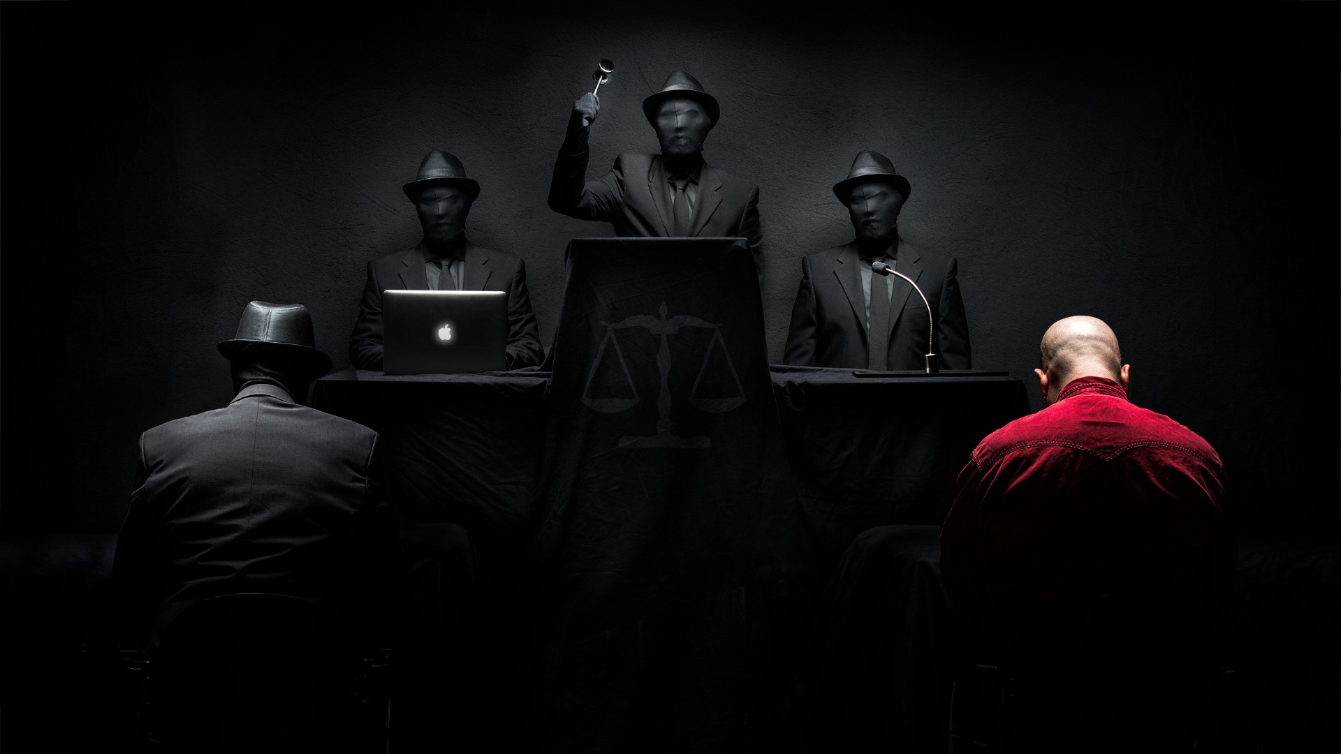 People in suits and hats in a dark room with a man in red HD Wallpaper
