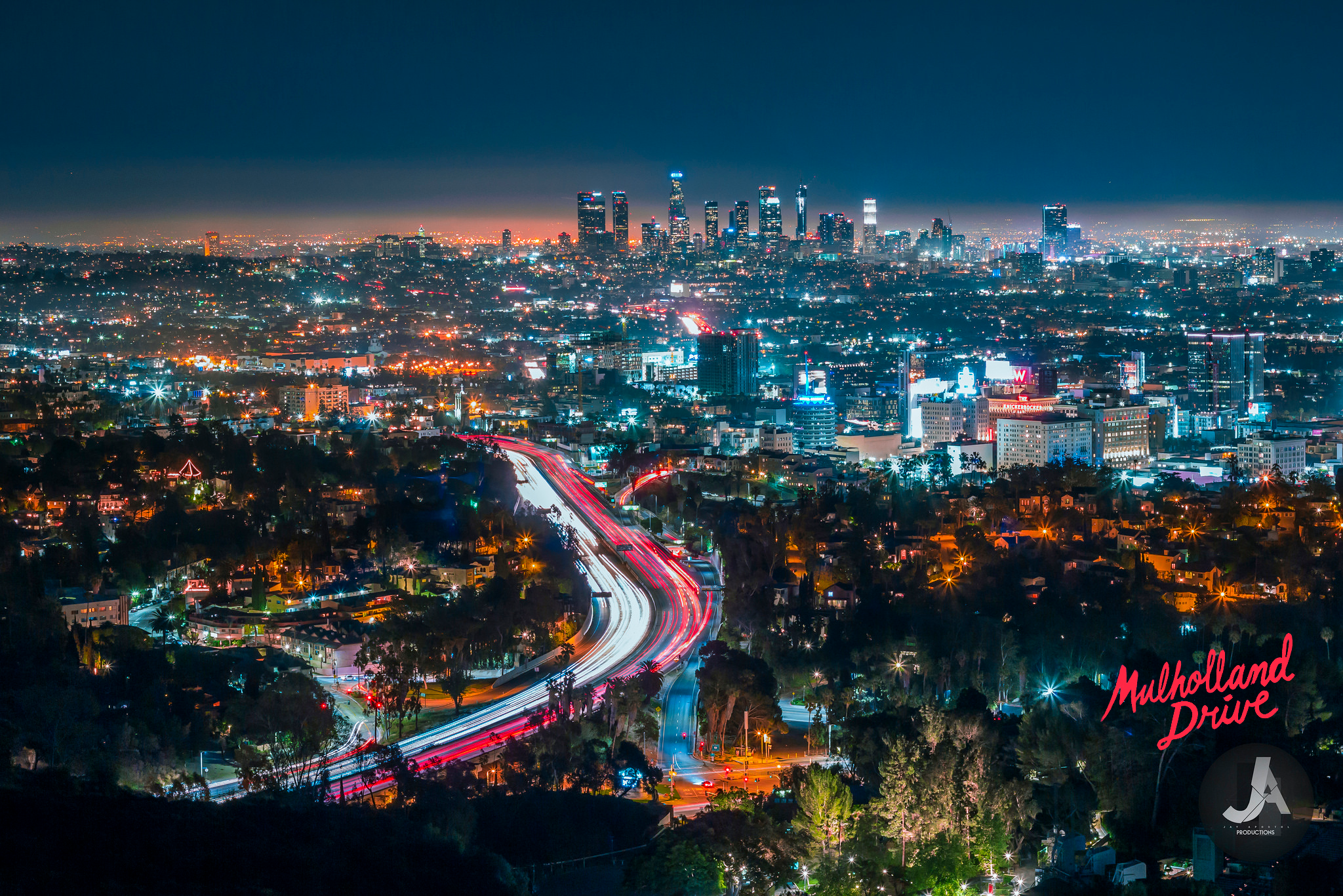Los Angeles cityscape with Mulholland Drive light trails at night HD Wallpaper