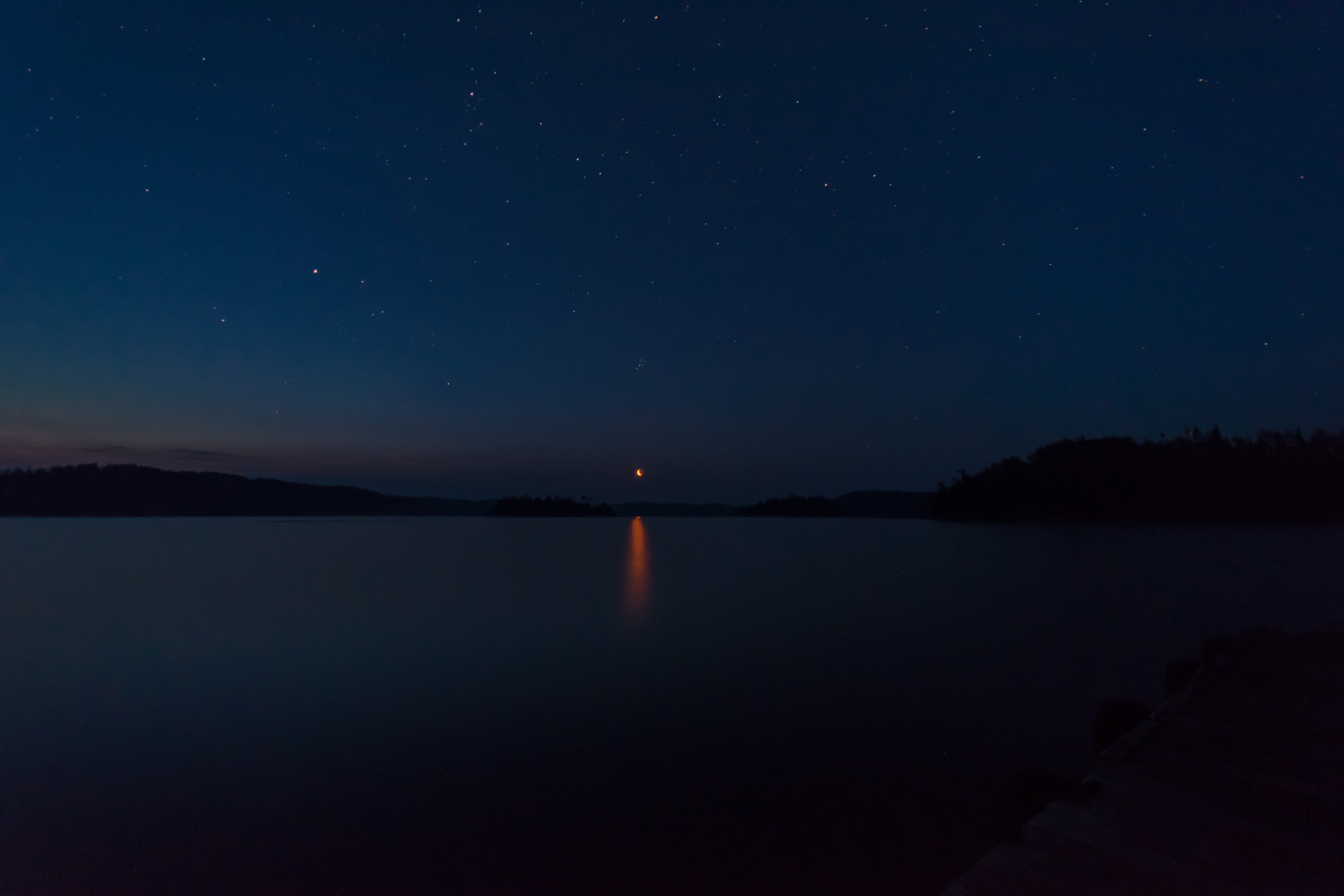 Night sky over a lake with stars and moon HD Wallpaper