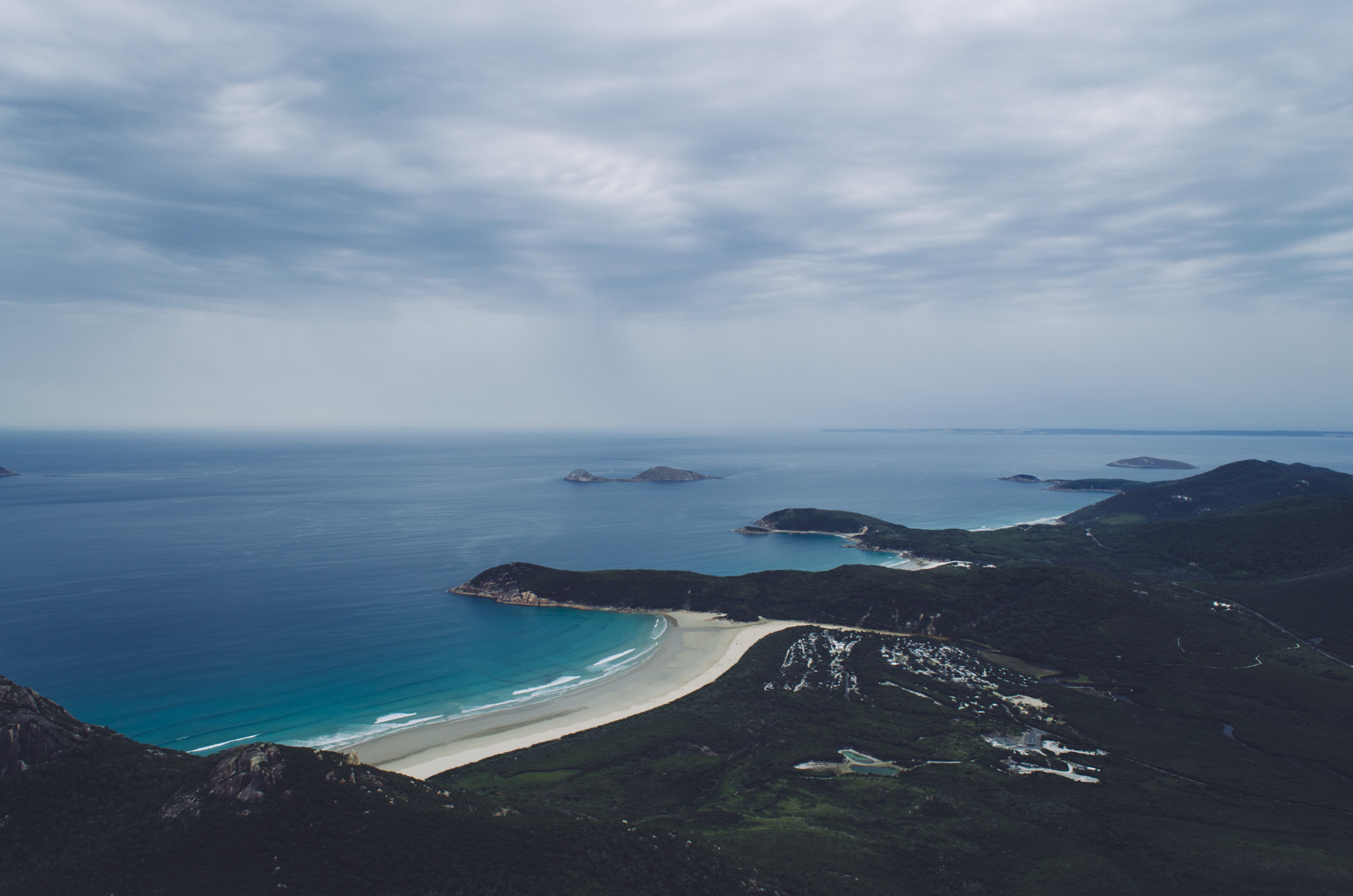 Coastal landscape with islands and cloudy sky HD Wallpaper