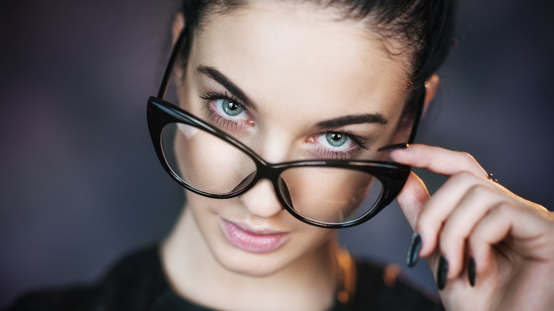 Woman with glasses looking over them HD Wallpaper