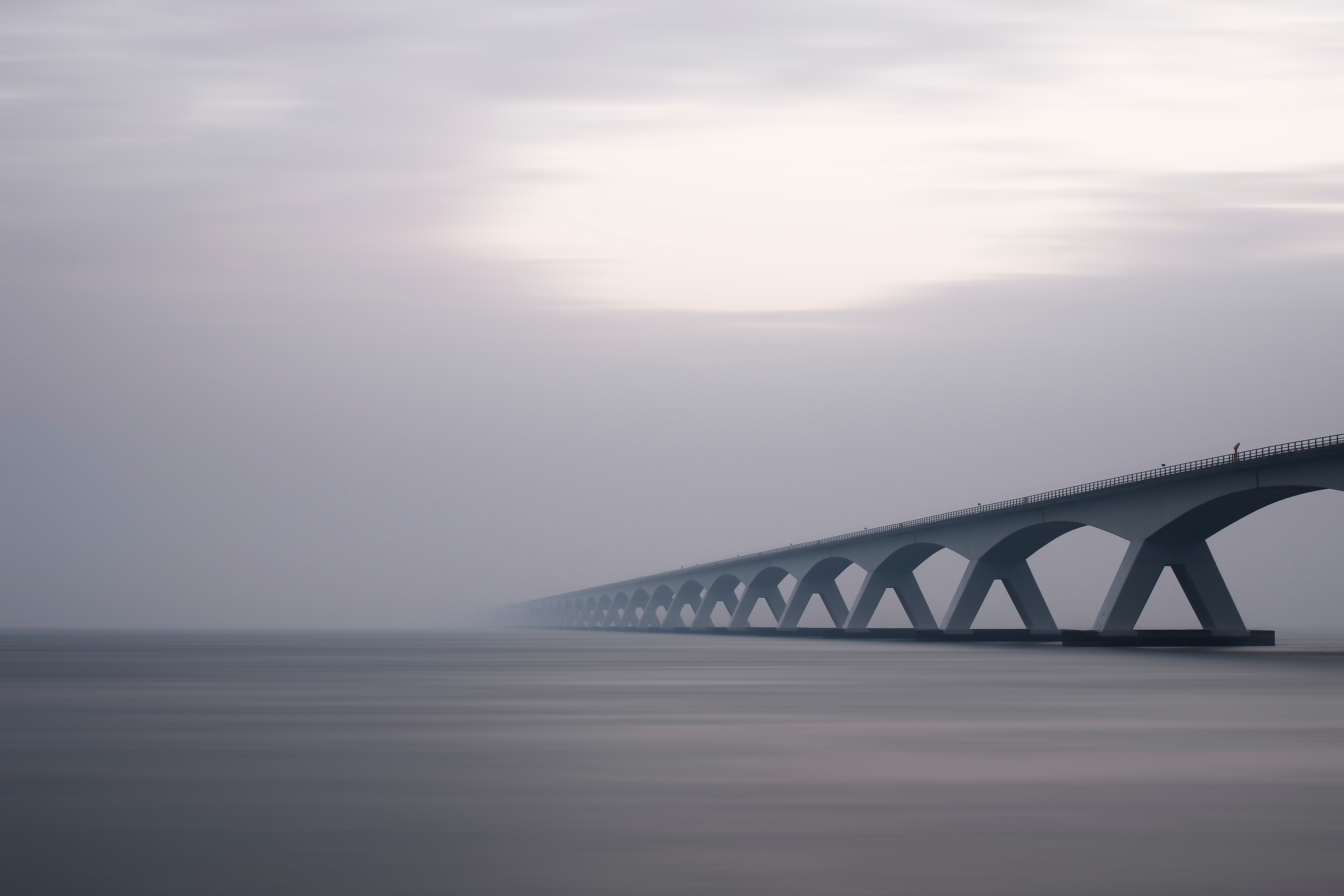 Zeelandbrug bridge over water in mist, long exposure HD Wallpaper