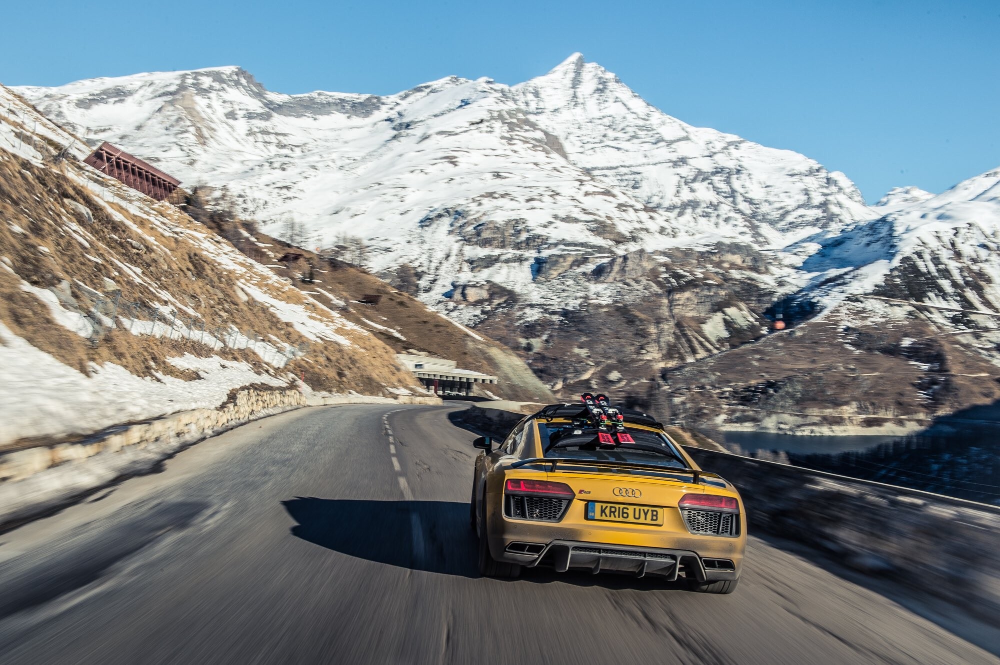 Yellow Audi R8 with skis on a mountain road HD Wallpaper