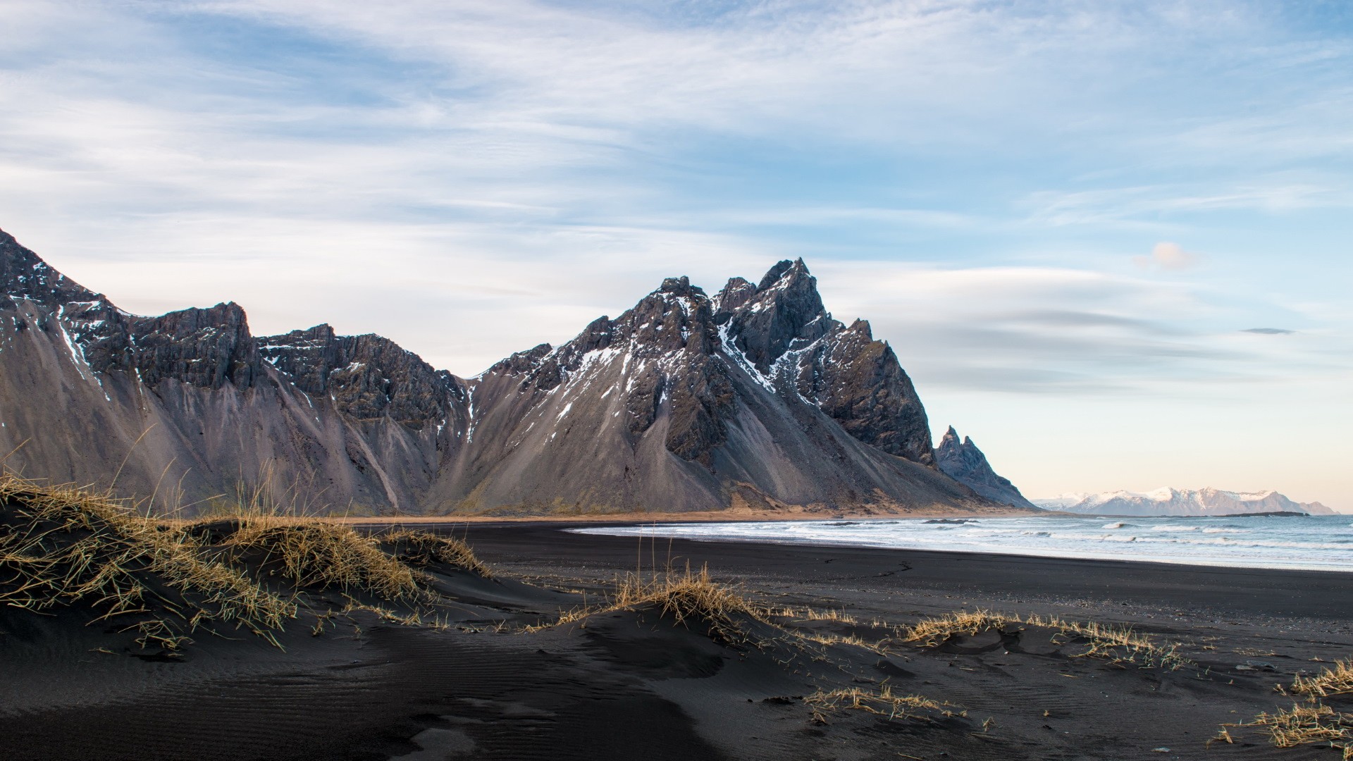 Black sand beach with jagged mountains in Iceland HD Wallpaper