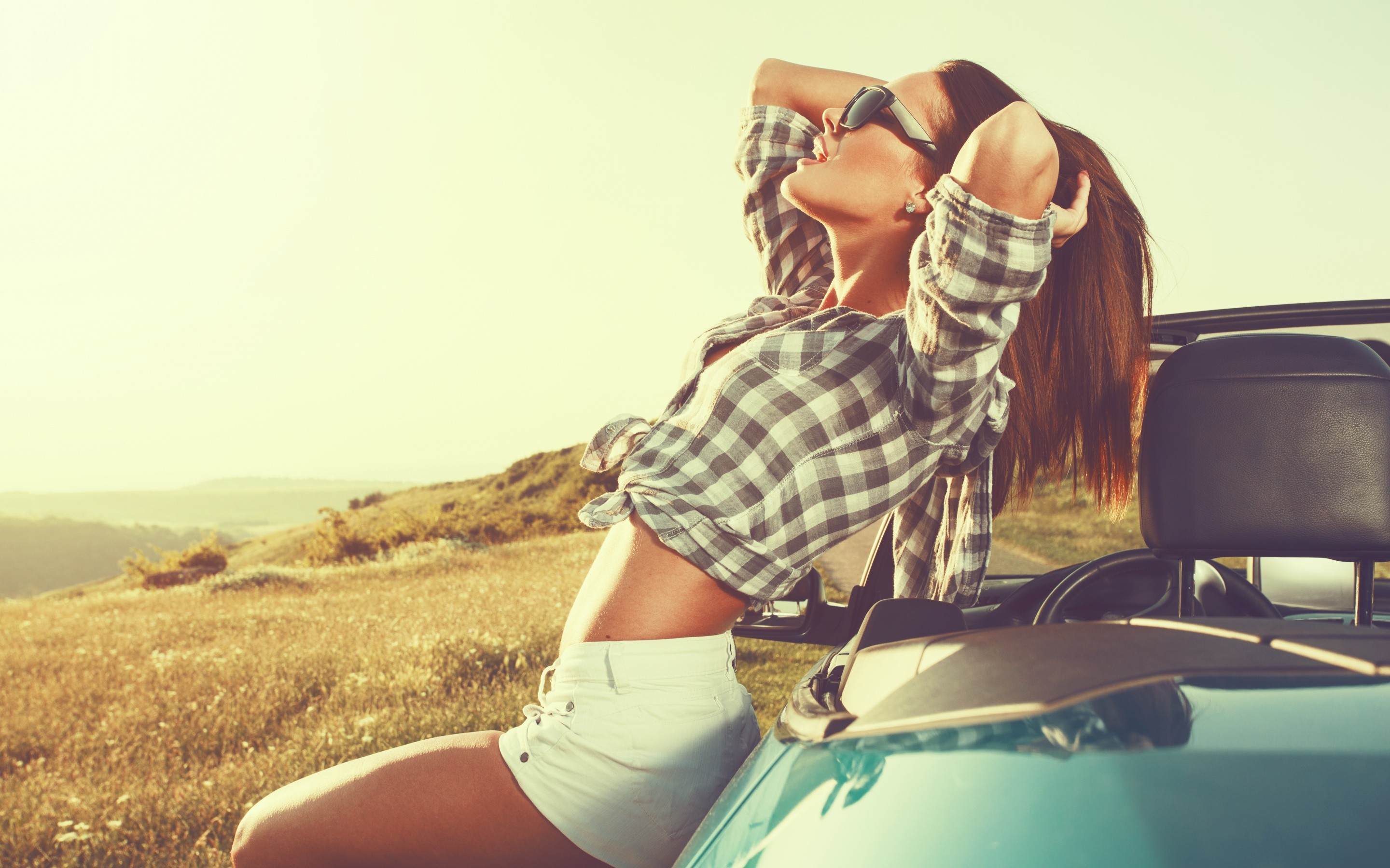 Woman in sunglasses and checkered shirt in a convertible HD Wallpaper