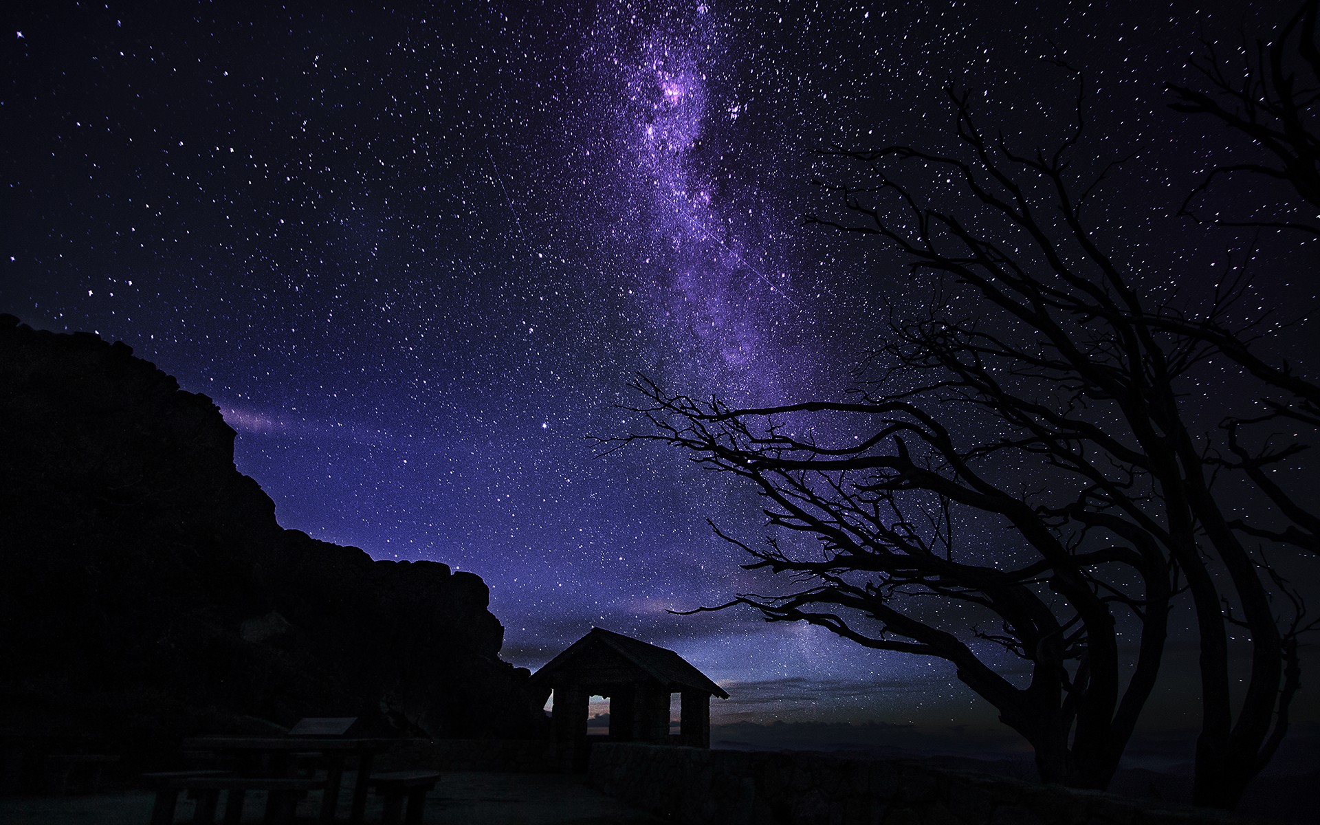 Milky Way over a cabin and trees at night HD Wallpaper