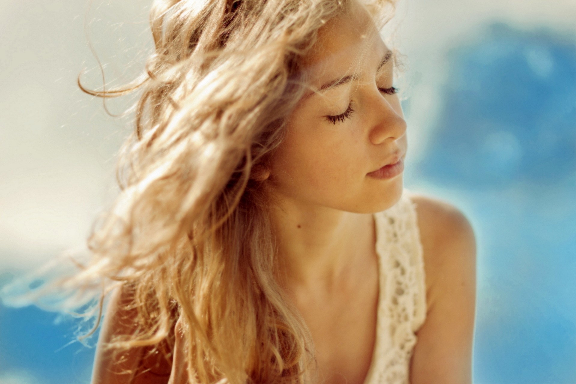 Young woman with blonde hair and closed eyes HD Wallpaper
