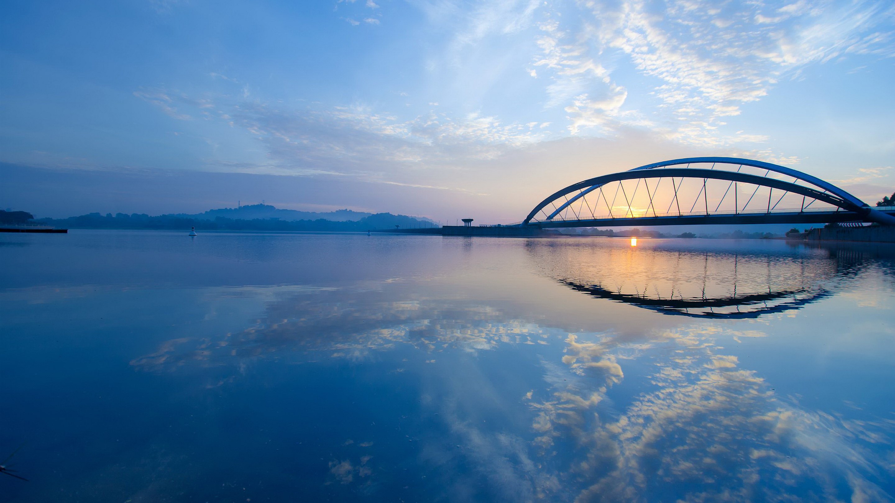 Bridge over a calm lake at sunrise HD Wallpaper