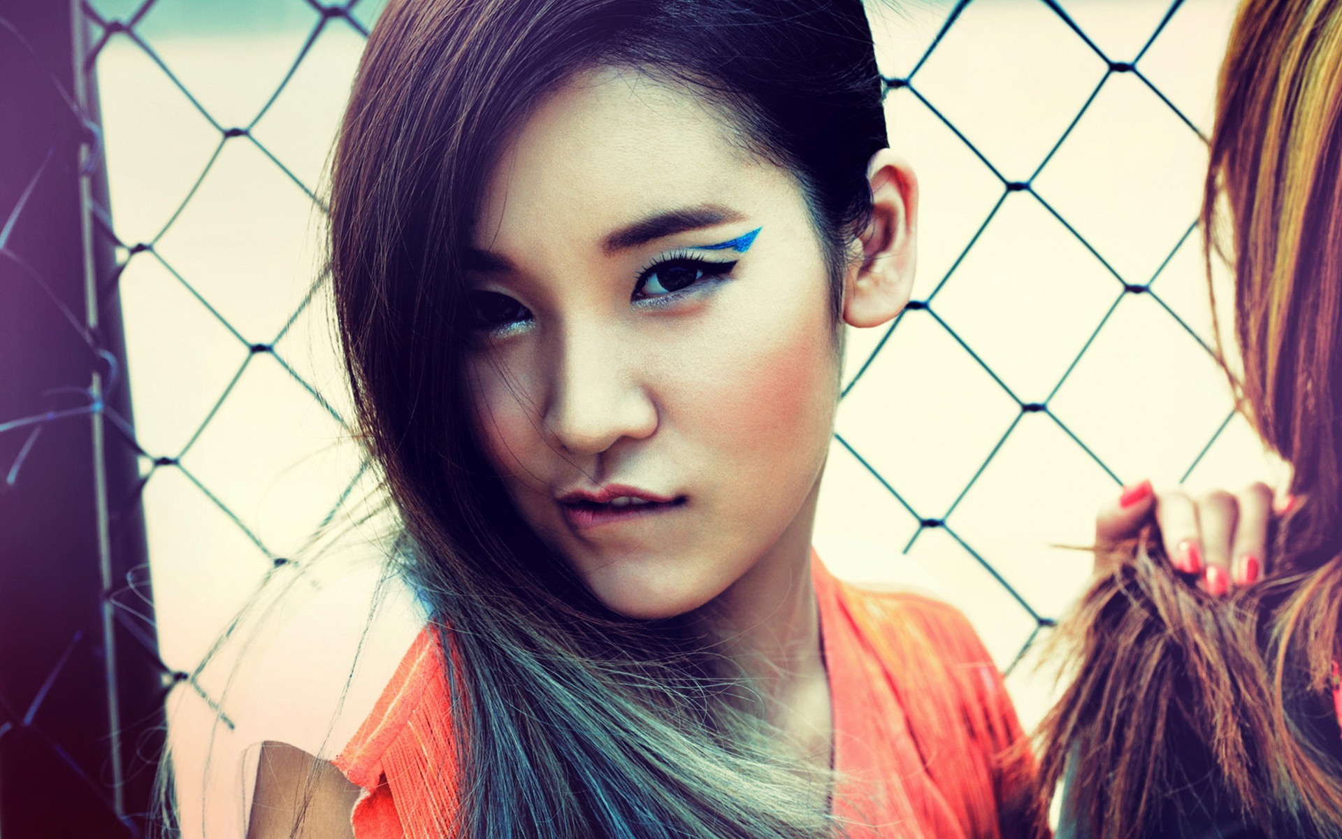 Two Asian women behind a fence HD Wallpaper