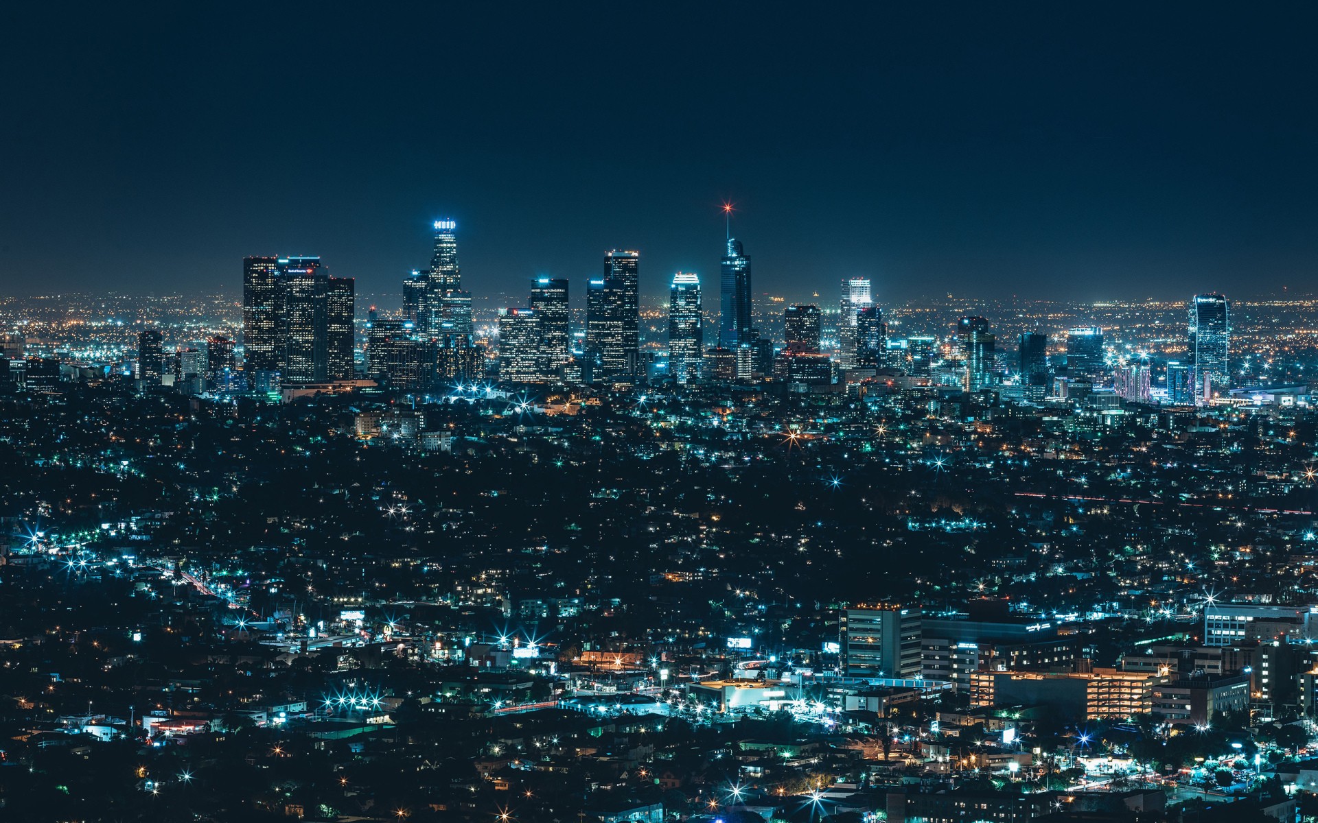 Cityscape at night with illuminated buildings HD Wallpaper