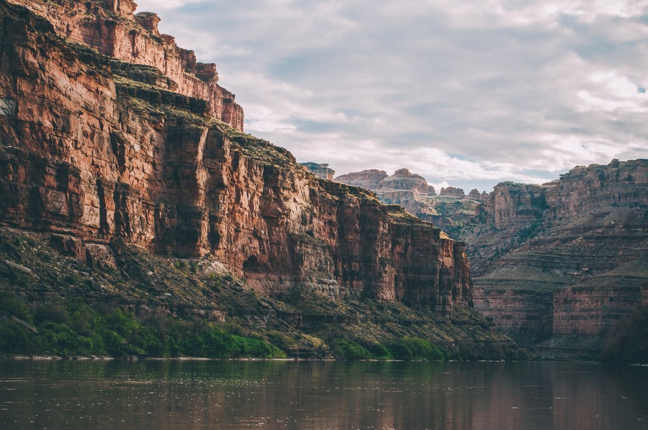 River flowing through a canyon with rocky cliffs HD Wallpaper