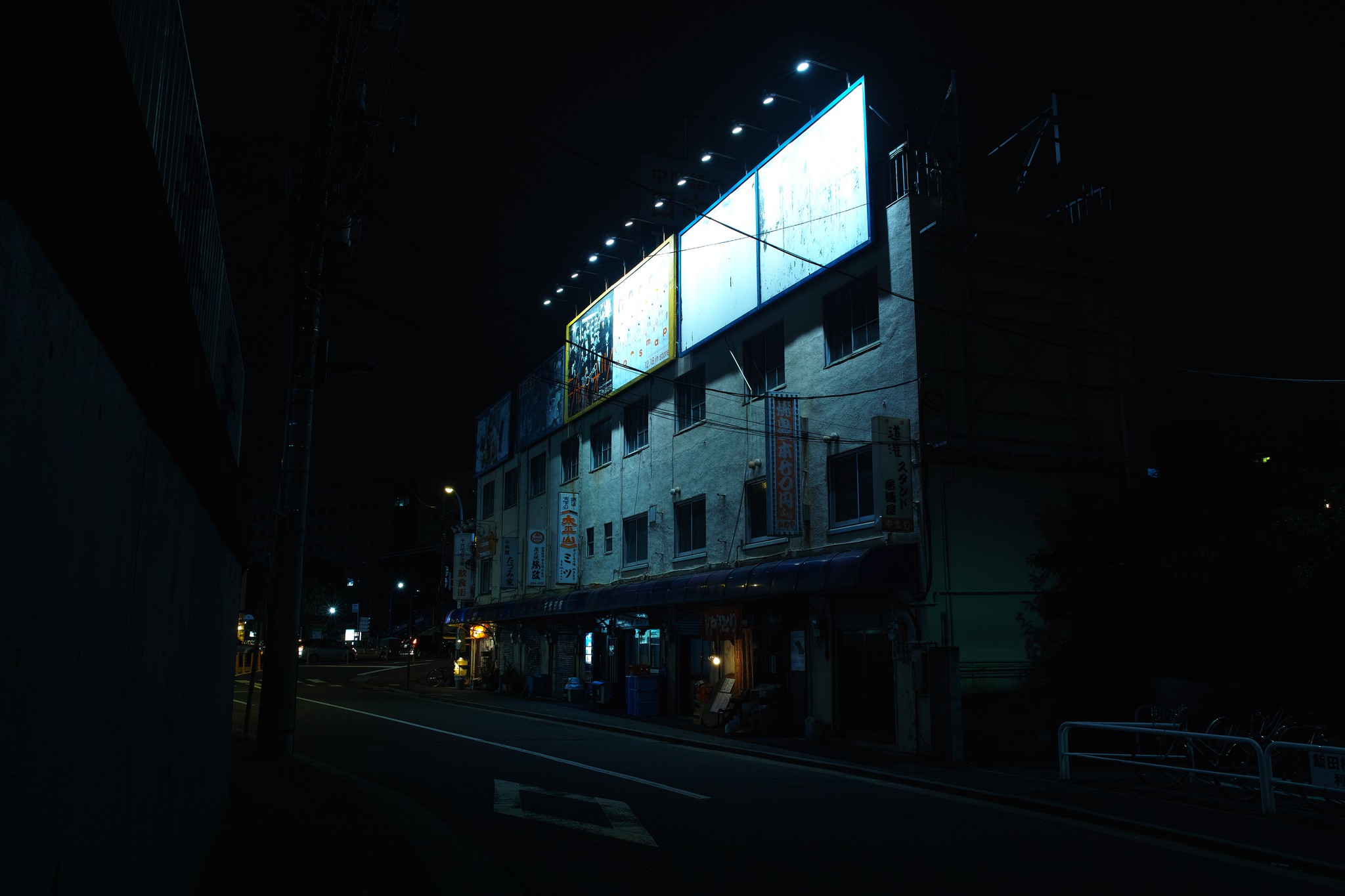 Night cityscape with illuminated billboards on a building HD Wallpaper
