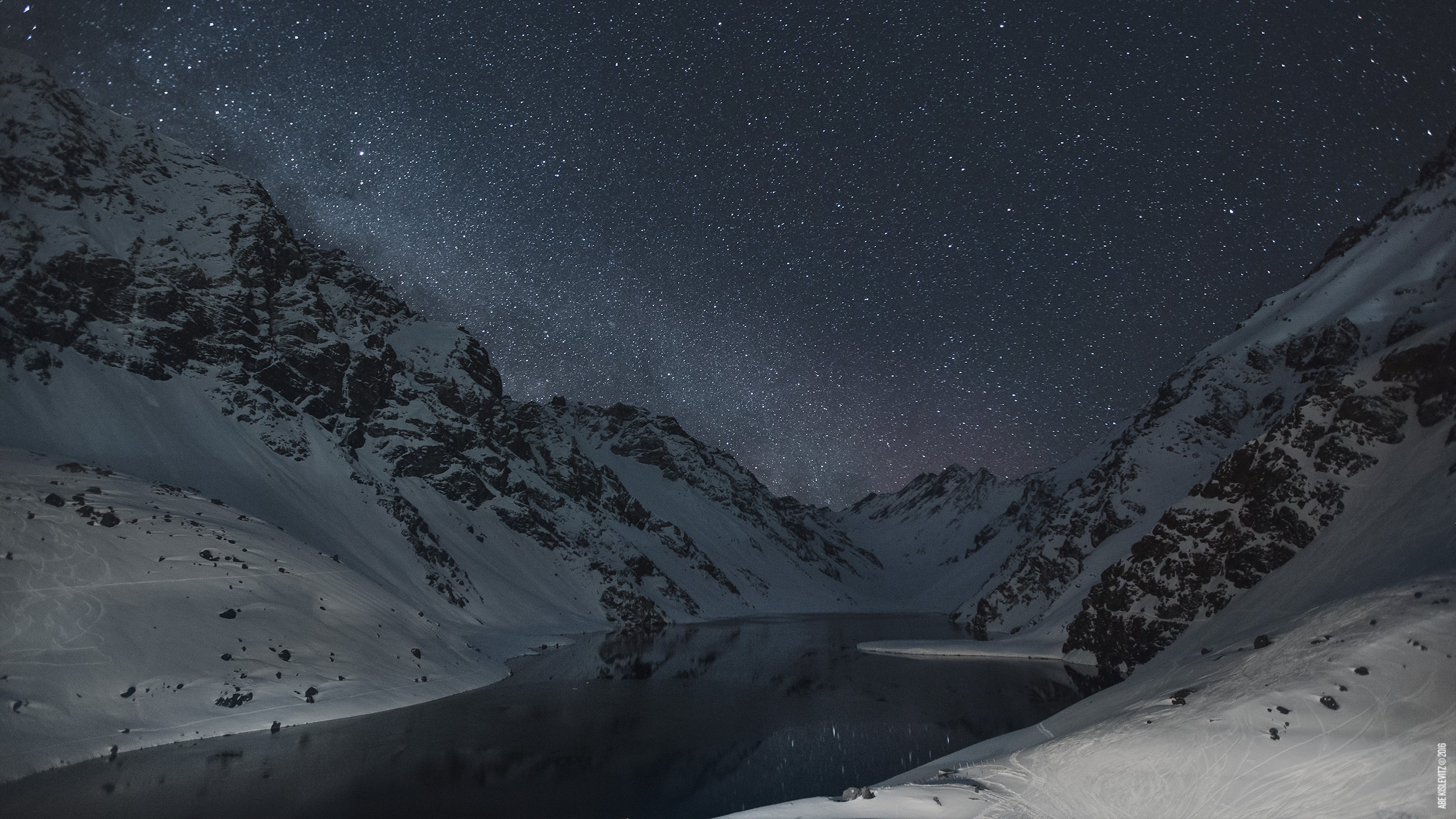 Snowy mountains and lake under a starry night sky HD Wallpaper