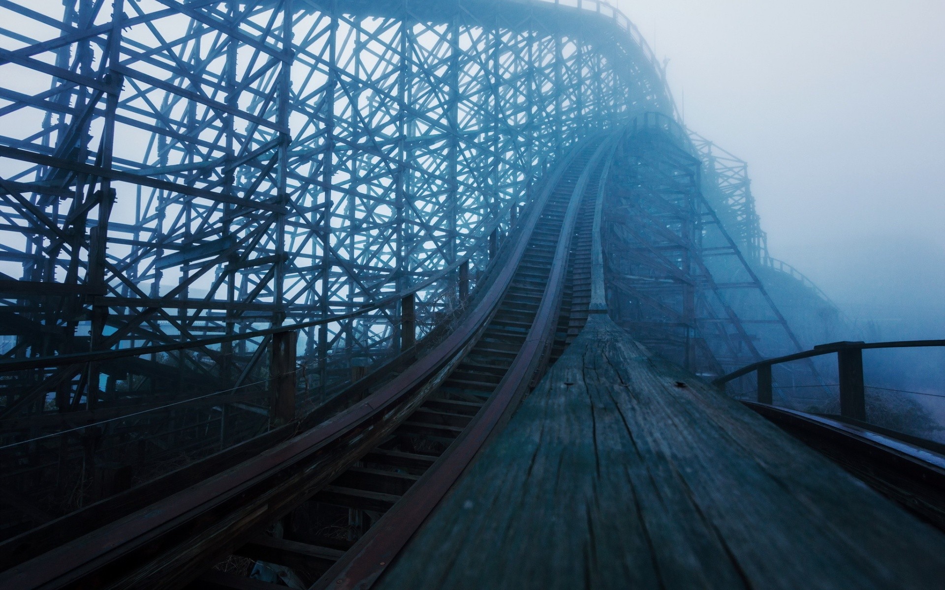 Abandoned wooden roller coaster in fog HD Wallpaper