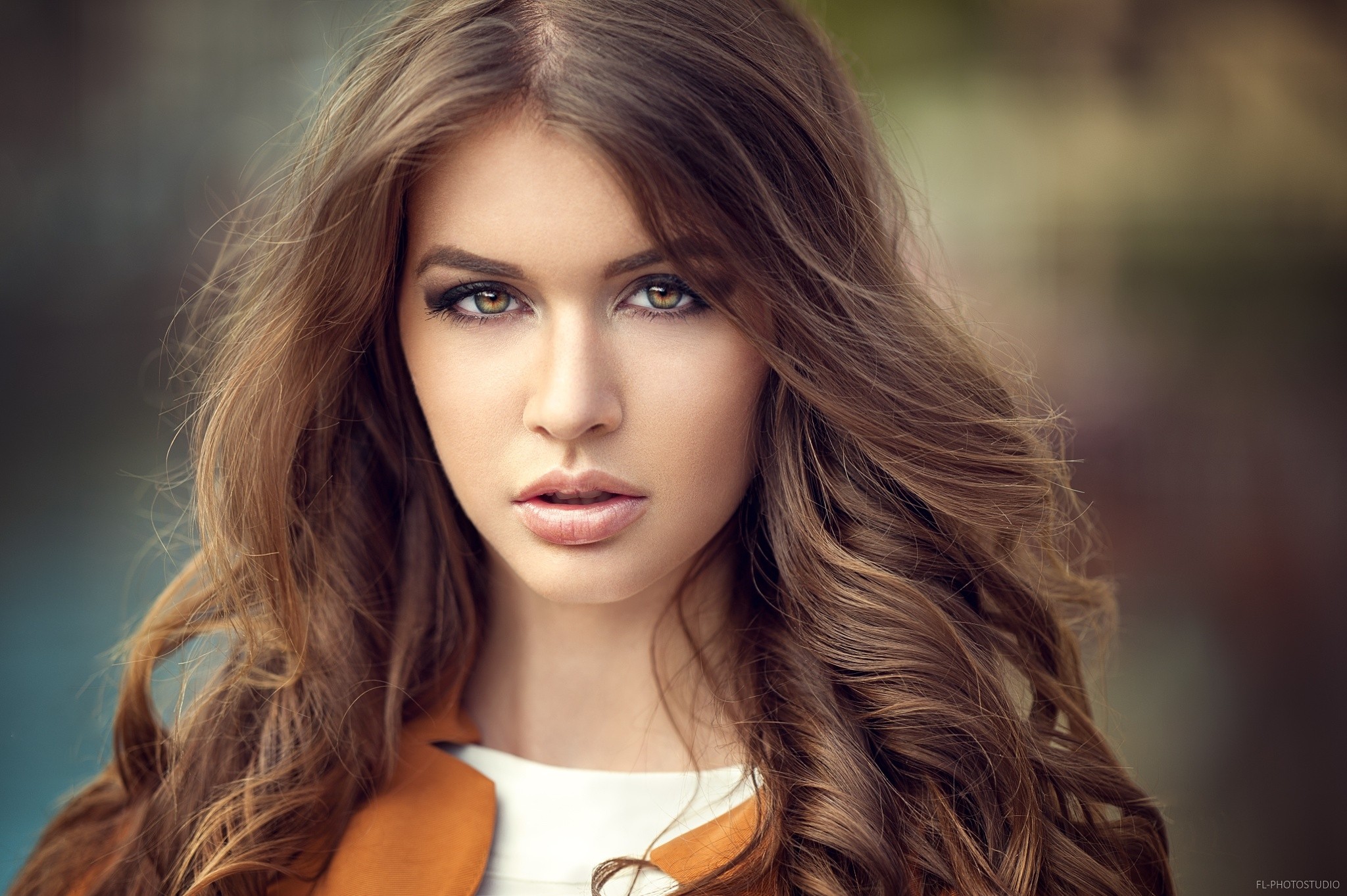 Portrait of a woman with brown wavy hair HD Wallpaper