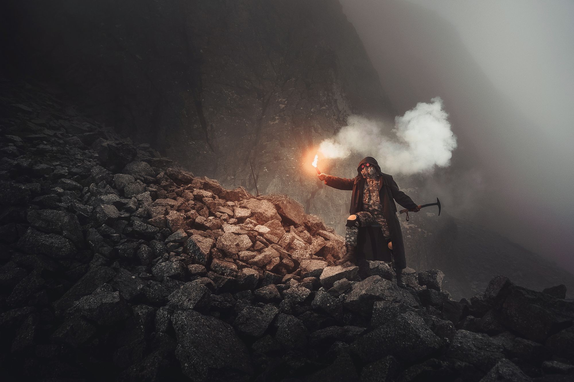 Person with flare and pickaxe on rocky mountain HD Wallpaper