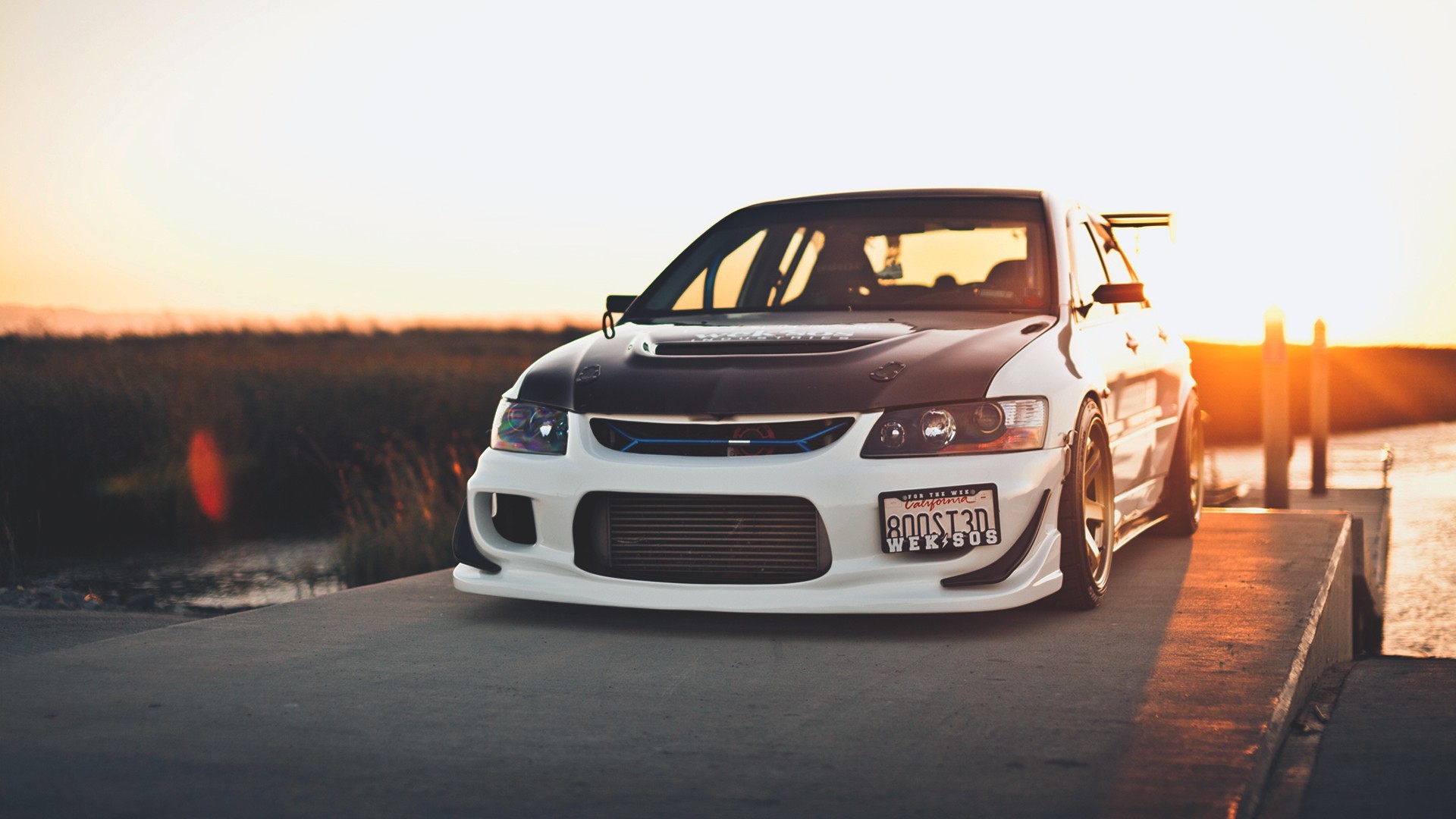 White Mitsubishi Lancer Evolution with custom body kit at sunset HD Wallpaper