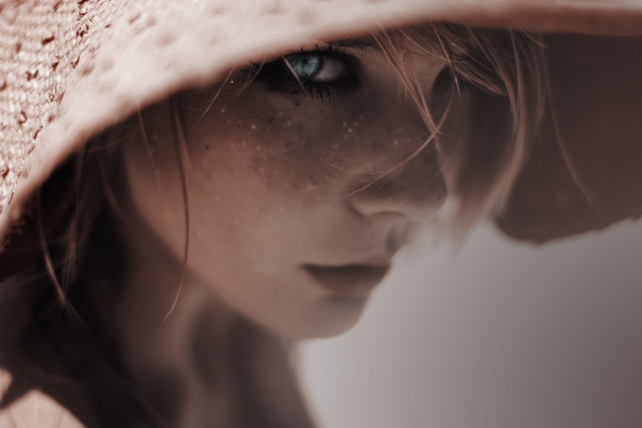 Woman with blue eyes and freckles wearing a straw hat HD Wallpaper