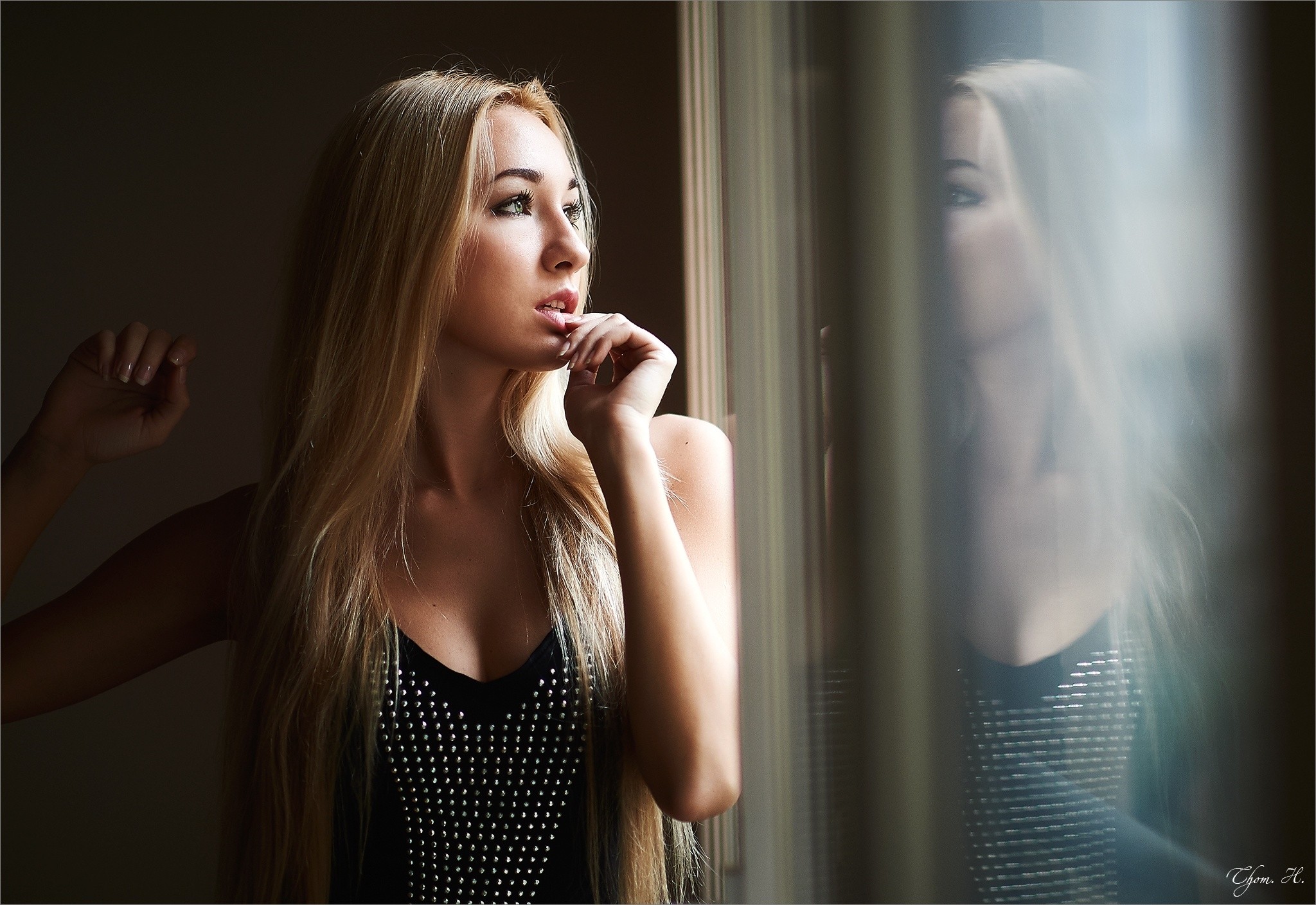 Woman with long blonde hair looking out a window HD Wallpaper