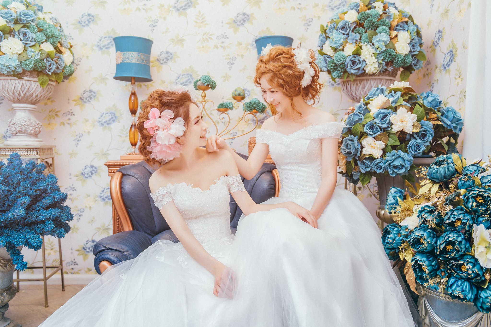 Two Asian women in wedding dresses with flowers HD Wallpaper