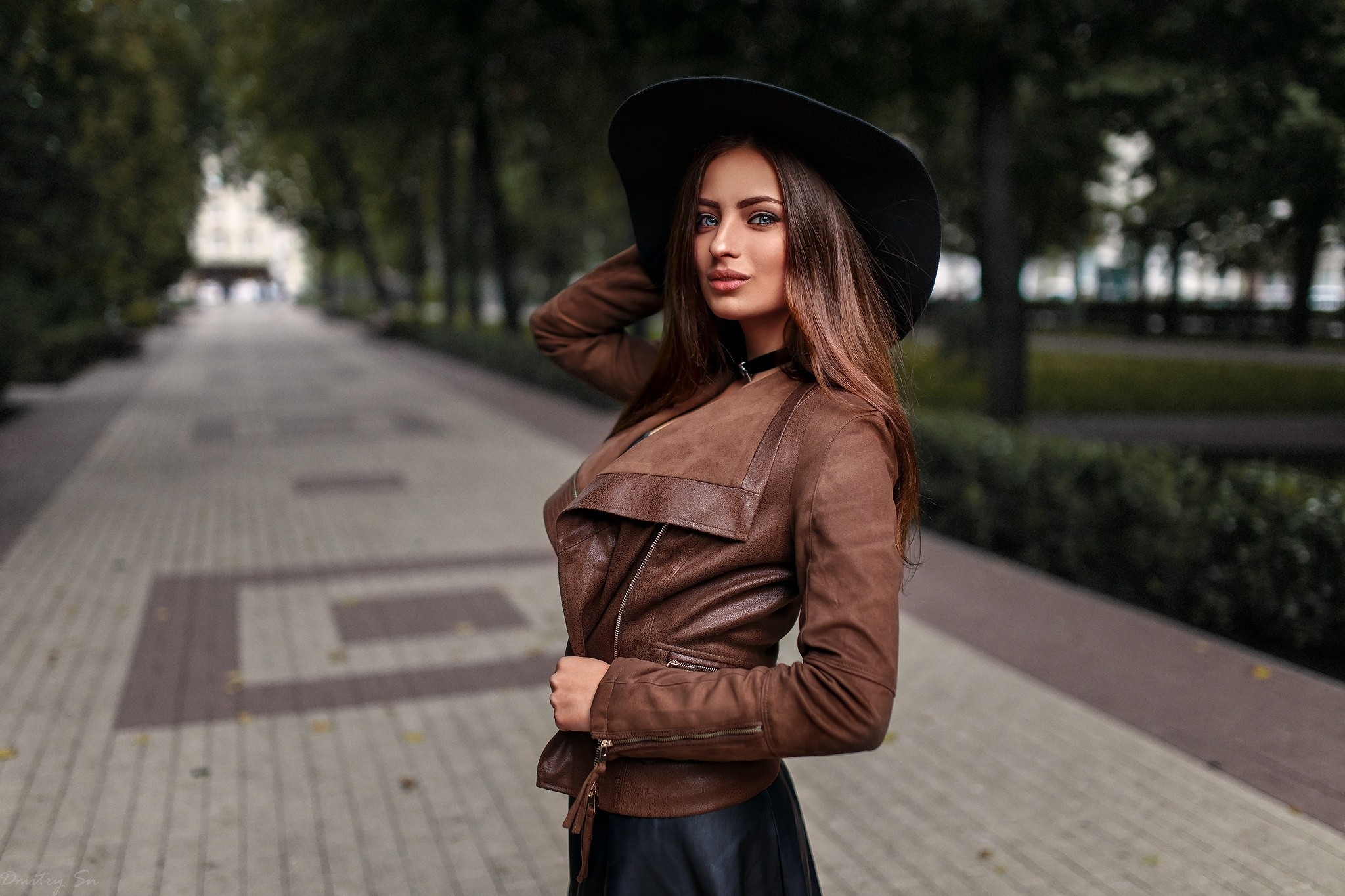 Woman in a hat and leather jacket in a park HD Wallpaper